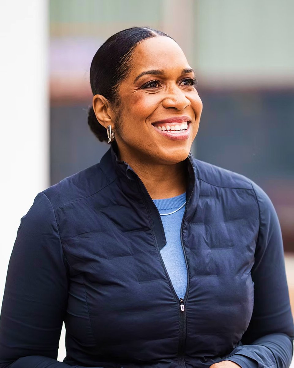 A photo of Juliana Stratton in a navy zip-up smiling.
