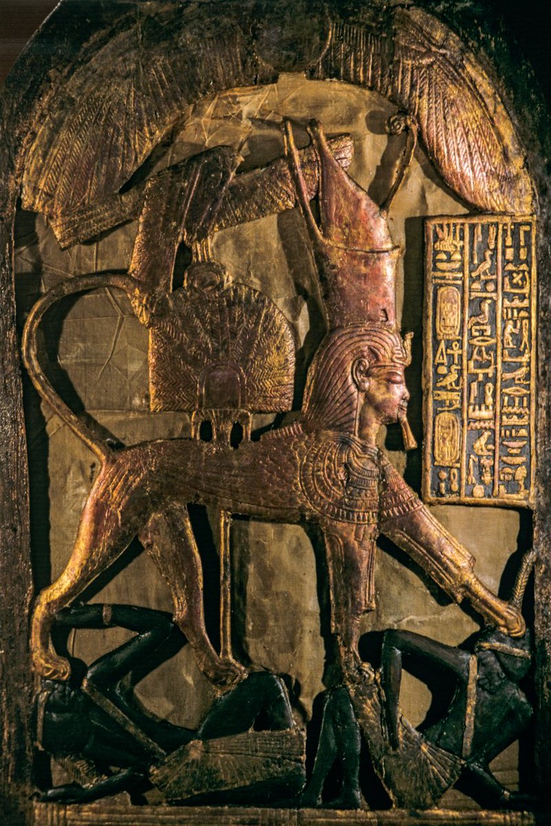 egyptomuseum's tweet photo. Ceremonial shield depicting Tutankhamun as a Sphinx Trampling the Enemies of Egypt

New Kingdom, late 18th Dynasty, reign of Tutankhamun, c. 1332–1323 B.C.

Fashioned from wood, covered with stucco, gilded and inlaid with ebony, this ceremonial shield transforms Tutankhamun into a human-headed sphinx, crowned as ruler of Upper and Lower Egypt. Beneath his powerful leonine body lie two defeated southern enemies, representing Nubia and the lands beyond Egypt’s southern frontier. 

The image was not intended as a record of a particular battle, but as an idealised expression of kingship, showcasing the pharaoh eternally subduing the forces that threatened Egypt and maintaining divine order. Above, the winged sun-disc and a falcon grasping the protective shen sign proclaim the king’s divine protection and enduring sovereignty.

From the Tomb of Tutankhamun (KV62), Valley of the Kings, Thebes. Now at the Grand Egyptian Museum, Giza.

Photograph by Kenneth Garrett

Read more: https://t.co/ZDdmQCveEn