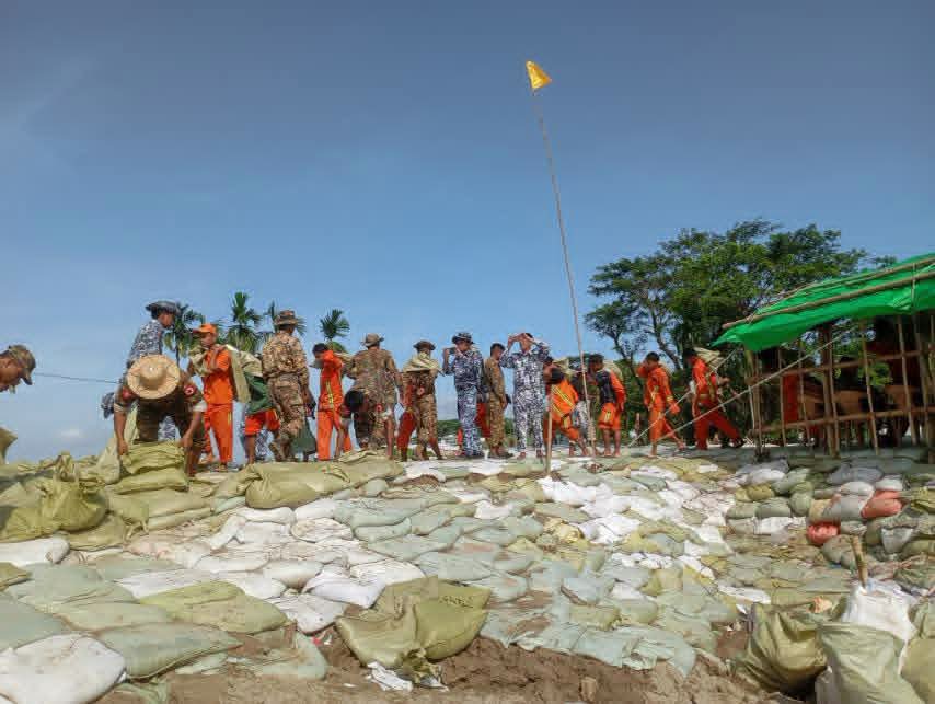 fsd_gov_mm's tweet photo. On 16.9.2026, at 07 30, firefighters, auxiliary firefighters, relevant organizations and residents carried out bamboo piling, sand filling and sandbagging at the embankment subsidence site between mileposts 11/5 and 11/6 in Chaungphyar Village, Nyaungdon Township, Ayeyarwady. https://t.co/Tov55HBx05