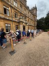 CastlesBritain's tweet photo. We paid £60 and never made it inside Highclere Castle
At Highclere Castle near Newbury, Hampshire—the real-life Downton Abbey house—we paid £60 for a 12.30 slot, then stood in a queue that barely moved for 45 minutes.
Tom and I had been looking forward to getting inside. I wanted the rooms and the traces of ordinary life behind all that television grandeur; he was ready to enjoy the architecture and tell me I was spending too long staring at doorways.
Instead, we spent our visit watching the queue inch forward.
After three quarters of an hour, we gave up and left without entering the house. That was the part that really stung: we had paid for a timed visit, reached the castle, and still decided that standing there indefinitely simply wasn’t how we wanted to spend the day.
The grounds didn’t rescue it for us either. After all that anticipation, walking away having never crossed the front door felt absurdly disappointing.
Highclere itself is magnificent to look at, but £60 and 45 minutes of queuing for a visit we eventually abandoned is a castle day I would not repeat.