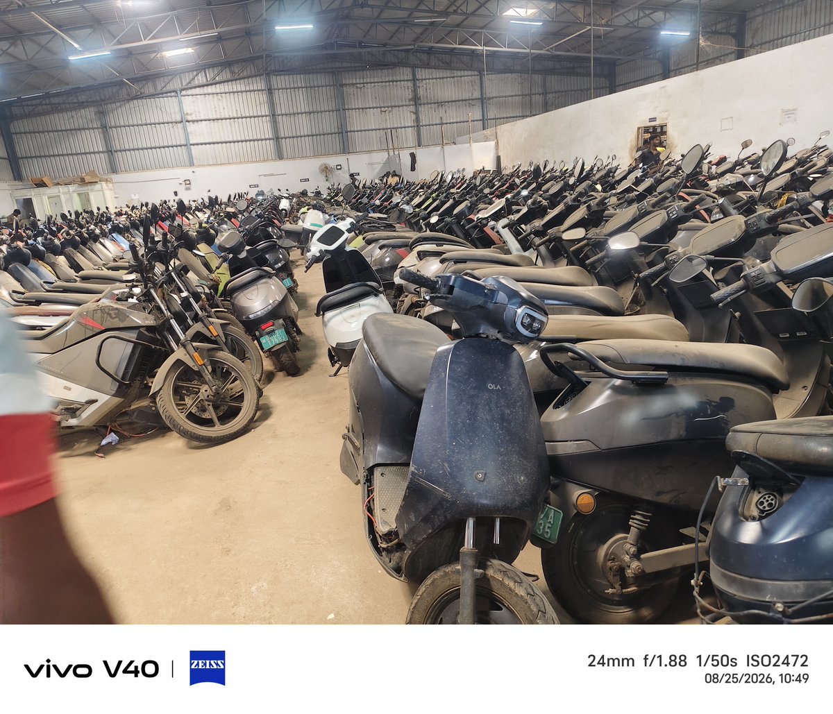 BunuRout's tweet photo. @bhash is the king of fraud and madarchod, behenchod too, This is OLA’s service standard: 3,000+ scooters reportedly stuck at a single service centre, with many treated like scrap. My scooter has been stuck for 3 months waiting for an MCU, despite just 2 years and 22,000 km. https://t.co/CJo0reepC1