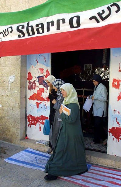25YearsAgoLive's tweet photo. Al-Nablus University in the West Bank sets up an exhibition celebrating the 9 August bombing of a Sbarro restaurant in Israel, in which 16 civilians were killed. 

The Palestinian Authority makes the effort to build a mock Sbarro storefront and include props of mutilated body parts, to trumpet the perceived success of Palestinian resistance against Israel. 

Visitors are required to walk over Israeli and American flags to enter and leave the exhibition.