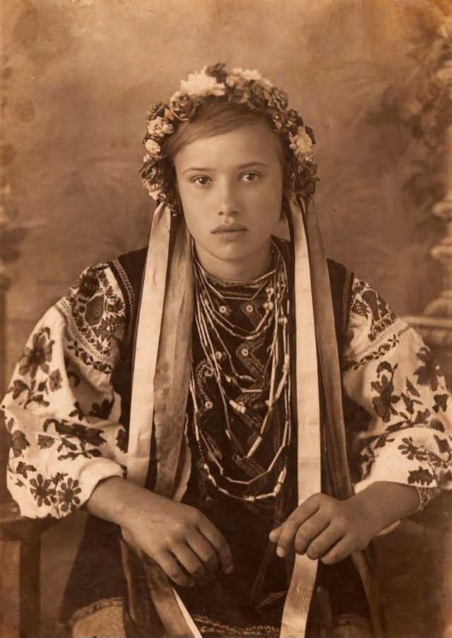 archeohistories's tweet photo. A fifteen-year-old Anastasiia Tkachenko wearing traditional Ukrainian attire in Merefa, Ukraine, on August 21, 1939...

She looks composed. Almost serene. She is dressed in an embroidered vyshyvanka (traditional shirt) and a dark vest, adorned with layered beaded necklaces (zardanky or coral beads) and a floral headpiece (vinok) with long ribbons hanging down the sides.

But the girl in this photograph had already survived something that had destroyed much of her family.

During the Holodomor of 1932–1933, Anastasiia lost her father, a younger brother, and two sisters. She and her brother Semen survived because their mother found work at an orphanage in Merefa and was able to bring her two remaining children with her.

The famine devastated communities across Soviet Ukraine. In Merefa alone, records associated with the Holodomor memorial project identify roughly 1,200 victims and a mass burial site near the railway station.

Anastasiia was still a child when she lived through it.

Six years later, someone pressed a camera shutter.

That ordinary moment is what makes this photograph so difficult to look at once you know the story. She is not pictured starving. She is not surrounded by ruins. She is simply fifteen, dressed beautifully, standing in front of a camera after surviving years that had already taken her father and three of her siblings.

And she kept living.

Anastasiia Tkachenko survived into old age, dying on April 26, 2018, at 94.

The photograph remained in her grandson’s family archive, a small surviving piece of one woman’s life after enormous loss.

#archaeohistories