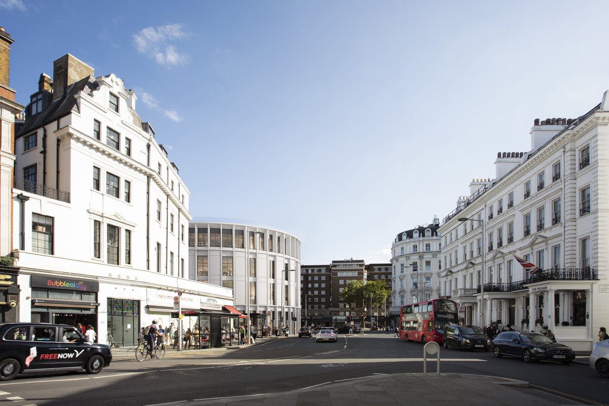 Architectural visualisation of the proposed South Kensington Underground station upgrade, viewed from Cromwell Place, showing the station entrance and surrounding streetscape with white Victorian buildings, shops, traffic and pedestrians.