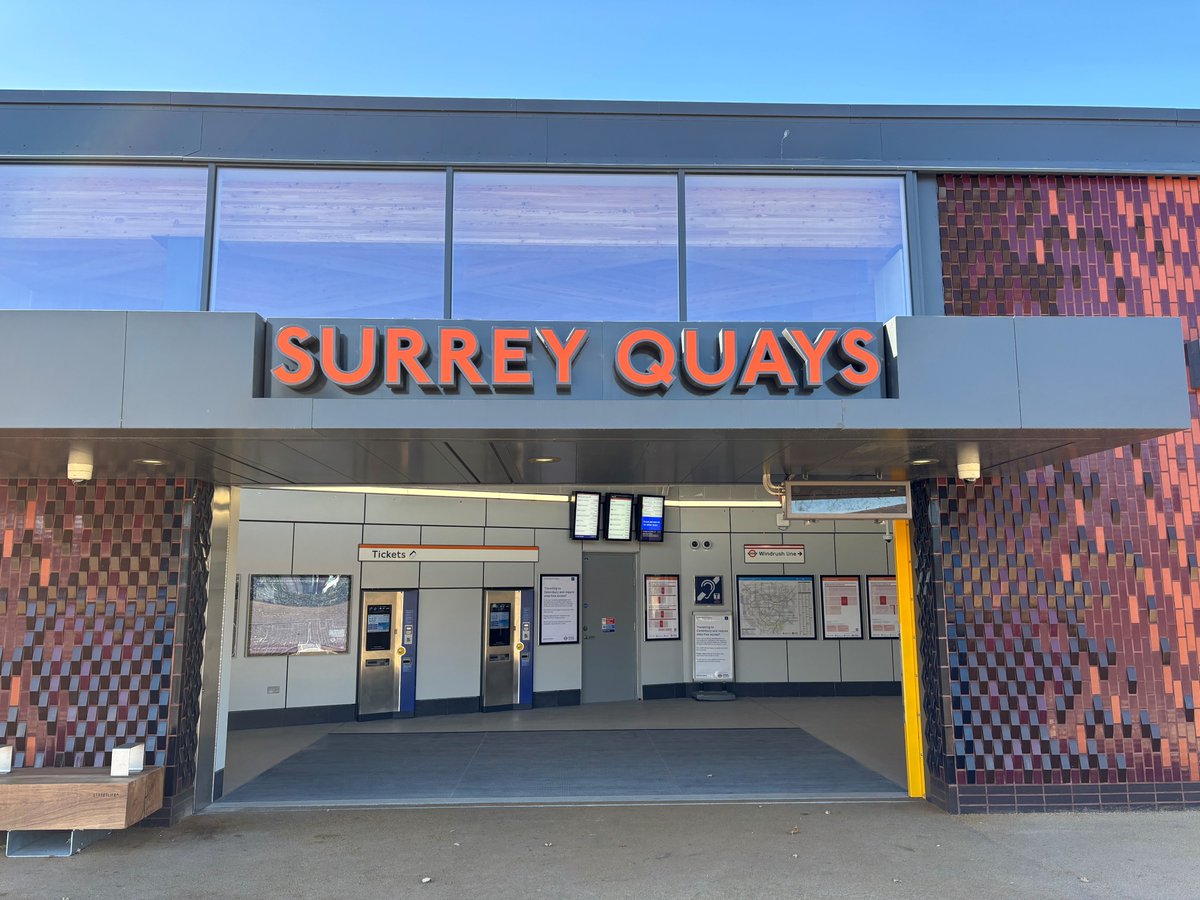 Surrey Quays station entrance, with the station name displayed above the doors.