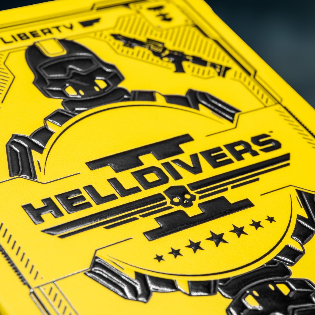 helldivers2's tweet photo. ATTENTION, CITIZENS.

Your hands serve Super Earth two ways: calling Stratagems, and dealing a hand so clean the whole crew falls silent in respect.

We've issued standard equipment for both.

Matte black. Blazing yellow. Custom faces, pips, and aces, not one stock card in the ranks.

♠️ Hive Lords & Bile Titans
♣️ Factory Striders & Devastators
♦️ Harvesters & Overseers
♥️ Super Earth's finest

Deploy the deck. Spread Democracy.

Get yours: https://t.co/g2TpM7Cs16

#GiveEmHell 🦅