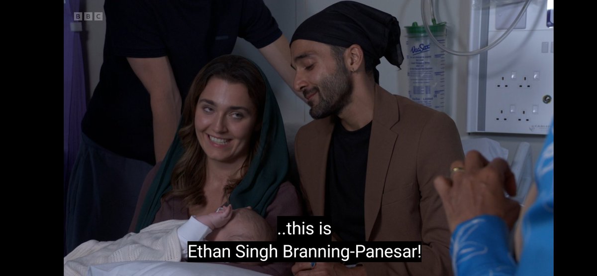 RyanSoapKing25's tweet photo. #EastEnders #Sukeve #Brannesar Beautiful scenes at the hospital where the Brannings and the Panesars gather for the Namm Karan ❤️ ( A Sikh naming ceremony) 🥺 

 I loved these scenes at the hospital today - it's good to see the show raising awareness on the sikh tradition of naming a child and I loved how Suki led the ceremony especially as we know how much her religion and faith means to her. 

Welcome to the world..... 

" Ethan Singh Branning Panesar" 🥺❤️ 

So that's one major plot point of the Flashforward officially resolved with Ethan being Penny/Vinny/Harry's baby by the time we reach the Flashforward. However there's still a major question mark over Penny and Vinny's whereabouts at this point as they don't appear in the episode 👀🤔 I assume the baby twist will be out at this point but with Jack left holding the baby - Where is Harry Vinny Penny etc?? 

I like how Jack got to choose the name - we know he wouldn't have picked a traditional sikh name for the child - I think the fact that Jack picked the name was also subtle Foreshadowing to the Flashforward with Jack left to look after the baby. 

Not Oscar wanting to call the baby Edgar Eric or Enoch 🤣🤣 Edward would've been a nice name too - Ricky calling the name Elliot common was funny. 😂

At least we know whatever happens that the baby will be called Ethan and if the baby is Harry's he's got no intention of changing the name that was  chosen for him. 

Such a beautiful scene sadly tinted by Penny's game changing baby secret. I love Penny as character and Kitty Castledine is spectacular but the way Penny is being written in this storyline is bothering me so much. She's had chances to tell Vinny the truth, she's kept Harry in the dark despite knowing they slept together, she faked a DNA test and kept it hidden from Vinny, she's lied to Priya about the Ethan's paternity and now she'll keep Lauren in the dark about her having another brother or sister. It's all just really messy and complicated stuff that wasn't needed. I hate how they're destroying Penny's character through this storyline and I wish they could retcon this silly baby twist that really wasn't needed. It's a rinse and repeat of the Arthur/Stacey/ Kush/Martin plot and I really can't see Vinny and Harry being joint dads to Ethan - it just wouldn't work and it would be way too messy. 😬 

What are your thoughts ahead of the Flashforward? Will Harry and Vinny raise Ethan together once the explosive fallout has died down? Or do you think Harry and Gina could raise a child of their own one day even though Gina doesn't want a child ( Priya felt the same way at one stage and now she wants to keep Max's baby it's completely bizarre) 👀