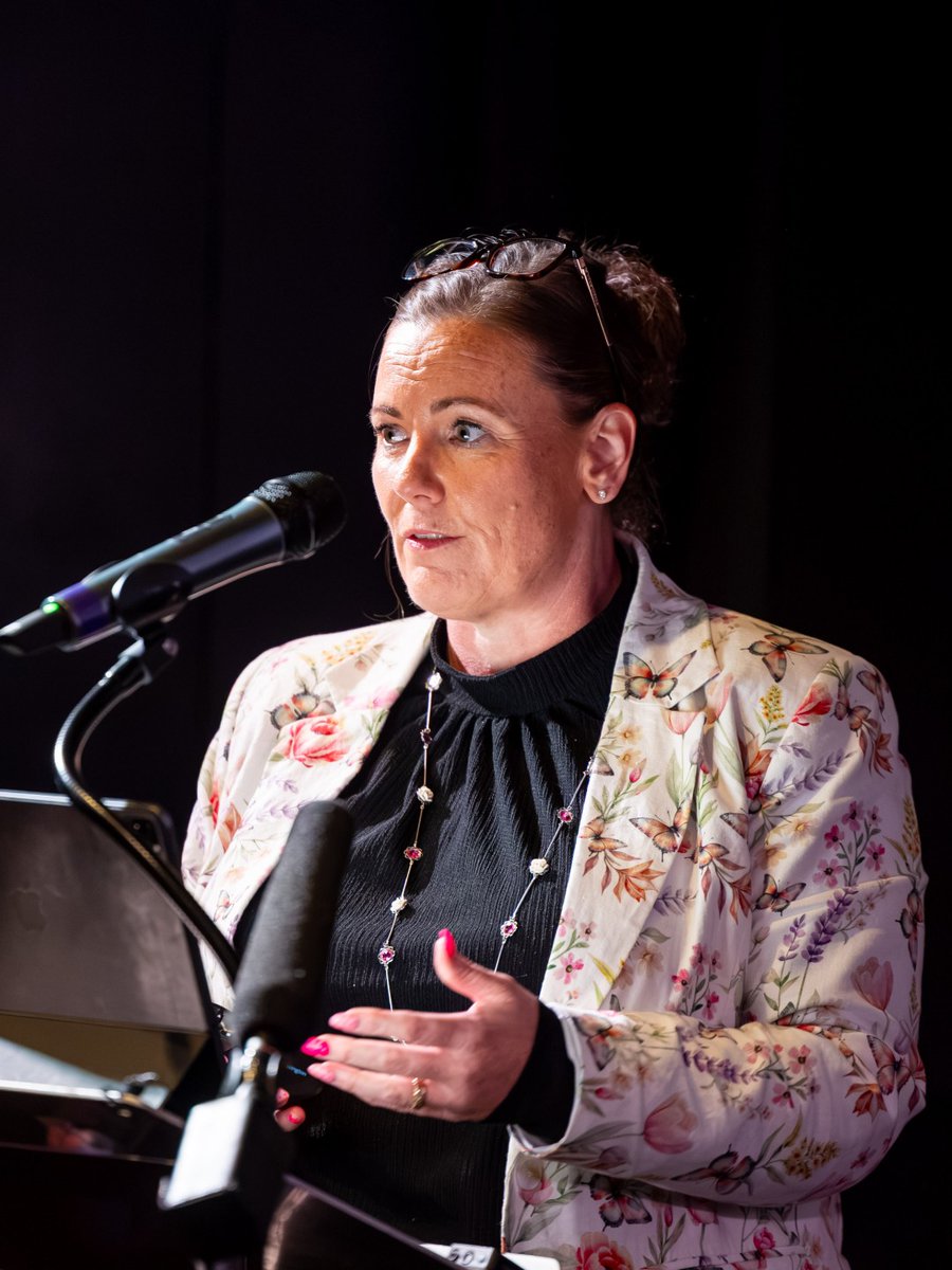 PSNI DCS Zoe McKee speaking at a podium for the 'Power to Change' campaign.