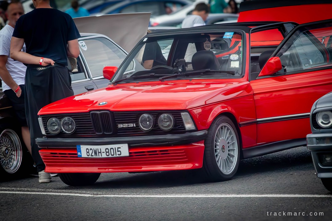 MonroeCalvwb's tweet photo. The bright red E21 323i Baur TopCabriolet at Mondello Park, with period-correct multi-spoke alloys and a clean front air dam. Would you take this open-top BMW on track or keep it for the road? https://t.co/pTWCdf0Oyy