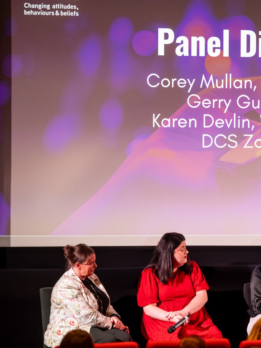 Panel with young ambassadors speaking at a podium in front of a 'Power to Change' campaign banner.
