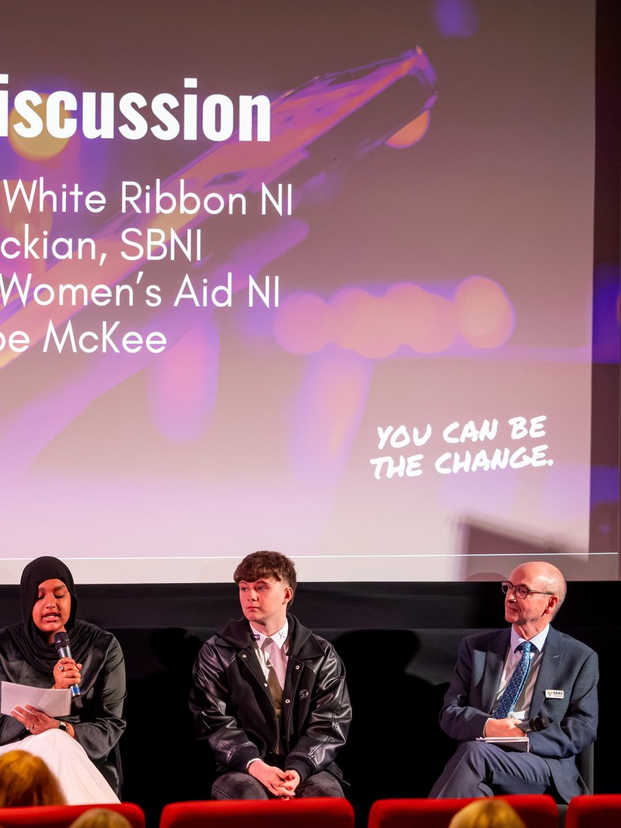 Panel with young ambassadors speaking at a podium in front of a 'Power to Change' campaign banner.