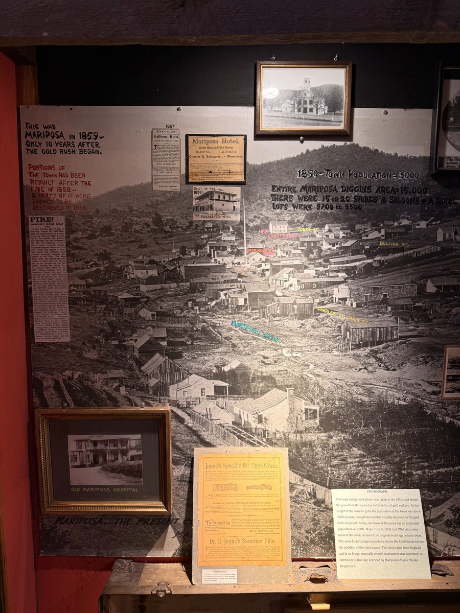 stevenbjohnson's tweet photo. The camera feature in the @Gemini_Notebook mobile app is so transformative for on-the-go research. I was up in the Sierras working on a new project, and I just took photos of everything, like this museum display. Then I asked for a detailed report of all the info in the image. The text below is what I got back. (I fact-checked it myself and it was 99% accurate -- and some of the text it transcribed is so blurry in the image that it was hard for me to read it.) 

Next step is to generate documents like this for all the photos I took, and then ask Notebook to highlight all the information that adds something new to the existing knowledge base of sources I've already collected, or is particularly relevant to my latest writing and outline for the project. Truly magical. 

Mariposa Museum Exhibit Reference: Mariposa in 1859 & Gold Rush Era
This reference document consolidates all text, photographic captions, historical statistics, newspaper clippings, and exhibit overlays displayed on the Mariposa Museum exhibit panel regarding Mariposa during and after the Gold Rush.

1. Exhibit Overview & Key Headlines
Main Title: "THIS WAS MARIPOSA IN 1859 – ONLY 10 YEARS AFTER THE GOLD RUSH BEGAN."
Historical Context Sub-headline: "PORTIONS OF THE TOWN HAD BEEN REBUILT AFTER THE FIRE OF 1858.. & PARTS OF IT WERE DOOMED TO BE DESTROYED IN 1866"
Display Overview: The exhibit centers on a large 1850s panoramic photograph of Mariposa, annotated with street names, landmark locations, and population statistics, flanked by contemporary hotel advertisements, fire reports, medical artifacts, and photographs of civic buildings.

2. Demographic & Real Estate Statistics (1850s vs. Present)
MetricHistorical Value (1850s Gold Rush Peak)Modern Value
Town Population~3,000 residents~1,800 estimated
Entire Mariposa Diggings Area~15,000 residents—
Commercial Establishments15 to 20 stores & saloons, plus hotels—
Town Lot Prices00 to 00 per lot—

3. Background Photograph & Civic Infrastructure
Background Photo Date: Taken in the 1850s, capturing the rapid growth of the settlement following the initial gold strike.
1854 Mariposa County Courthouse:
Shown in the background panorama prior to the construction of its iconic clock tower.
A separate framed photograph depicts the completed white wood-frame courthouse with a white picket fence and clock tower.
Clock Tower History: The clock mechanism was imported from England and is an 8-day, manually wound instrument. It remains operational today, maintained by the Mariposa Public Works Department.
Annotated Overlay Locations on Panorama:
1854 Courthouse: Located at the upper edge of town on Jones Street.
Jones Street & Bullion Street: Upper residential and civic thoroughfares.
Charles Street (Main Street): Primary commercial artery running through the center of the valley floor.
Schlageter Hotel Site: Positioned along Main Street.
Mariposa Creek: Flowing along the foreground basin of the town diggings.

4. The Fire of 1866: Mariposa's Second Great Conflagration
Below is the complete transcript of the Mariposa Gazette report featured on the panel regarding the disaster of August 25, 1866 (following the earlier destructive fire of 1858):

Article Text: "FIRE! MARIPOSA'S SECOND GREAT FIRE"
A few minutes after 6 p.m. on Saturday, August 25, 1866 Mariposa was again ruined by a disastrous fire (first in 1858). According to the Gazette (the building was damaged but not destroyed), the fire was believed to have started when "a recently imported printer stepped inside the Free Press office and lighted a cigar. The match had evidently been dropped carelessly amongst the papers on the floor. The Free Press office was located near the corner of Main and 7th Streets and by ten minutes the fire had spread through two blocks. The fire crossed Main Street to the Odd Fellows building and the Methodist Church and soon the buildings on the block between 6th and 7th Streets were burning like so much chaff." Seven full blocks, except for four fire-proof buildings, were totally destroyed. "In one hour about 60 buildings and 77,000 worth of property were destroyed."

By early Monday morning the men were clearing away debris and by press time the following Saturday, the Gazette reported that several temporary business structures had already been erected and were open for business.

Inventory of Buildings Destroyed in the 1866 Fire:
Residential & Civic: 14 Dwellings, 1 Church, 1 Odd Fellows and Masons Hall.
Media & Printing: 1 Newspaper Office (Free Press), 1 Newspaper Depot.
Hospitality & Retail: 3 Hotels, 5 Retail Stores, 1 Saddlery Shop, 9 Liquor Saloons (several equipped with billiard tables).
Services & Trades: 2 Livery Stables, 3 Law Offices, 1 Drug Store, 3 Blacksmith Shops, 2 Carpenter Shops, 2 Shoemaker Shops, 1 Tailor Shop, 2 Butchering Establishments.
Outbuildings: Numerous outhouses, private stables, and auxiliary structures.

5. Commercial Hotels & Lodging
Gallison Hotel (1887 Advertisement)
Location: Main Street, Mariposa (center of business district, opposite Odd Fellows' Hall).
Proprietor: Winslow Gallison.
Management: Mrs. Gallison individually superintended all internal departments of the hotel.
Amenities: Newly furnished rooms, first-class table dining.
Mariposa Hotel (1887 Card)
Location: Corner of Main and Fifth Streets.
Proprietor: Charles A. Schlageter.
Target Market: Accommodated general travelers as well as Yosemite tourists on short notice.
Amenities: Family rooms, well-lighted parlors, good table, and bath facilities.
The Schlageter Hotel
Date Built: Built in the 1850s.
Architecture: Prominent two-story wooden structure featuring full upper and lower covered verandas.

6. Medical Artifacts & 19th-Century Therapeutics
Old Mariposa Hospital
A framed historical photograph depicts a two-story wood-frame hospital building with a prominent front porch and side wing (annotated "from Chic Allingham").
Dr. D. Jayne's Family Medicines (1880 Display Broadside)
1. Jayne's Specific for Tape-Worm
Diagnosis: Describes tapeworm infections as widespread, noting that discharging white or yellowish segments ("resembling gourd seeds") is the only positive diagnostic proof.
Pricing & Ordering: .00 per dose, shipped nationwide via mail from 242 Chestnut Street, Philadelphia.
Usage Instructions: Dissolve powder in a pint of boiling water, drink in three equal hourly doses on an empty stomach. Follow with Cathartic medicines if bowels do not operate in three hours.
2. Dr. D. Jayne's Sanative Pills
Formulation: Concentrated, sugar-coated pills. Sold in 50-pill boxes (-bash.25) or 15-pill specimen packets (-bash.10).
Prescribed Ailments: Advertised for liver complaints, gout, jaundice, dyspepsia, rheumatism, kidney affections, fevers, nervousness, skin diseases, melancholy, sick headache, and costiveness (constipation).
3. Exhibit Commentary Note
A small museum card mounted below the broadside reads:
"A man advertises for 'a competent person to undertake the sale of a new medicine' and adds innocently 'It will prove profitable to the undertaker.'"