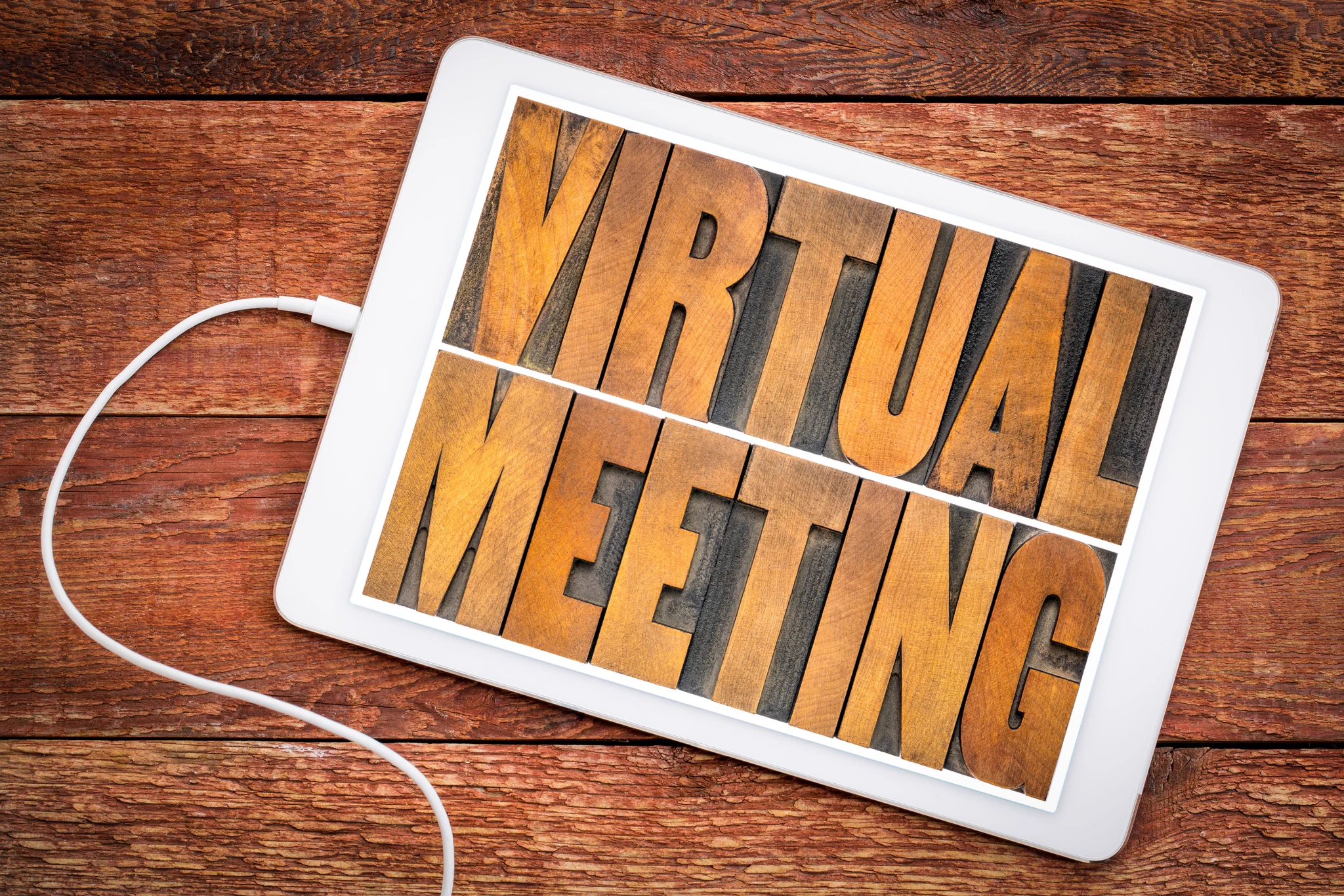 A tablet with the words: virtual meeting.