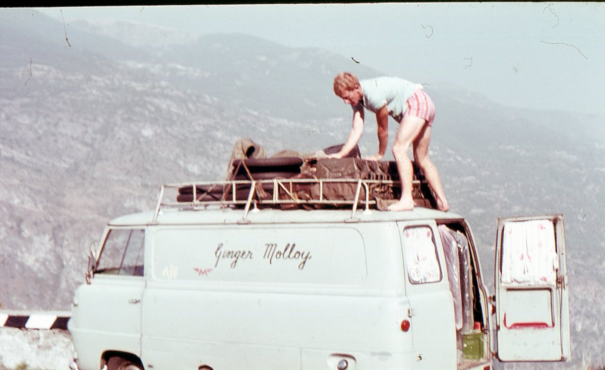matoxley's tweet photo. Very sad to hear Kiwi Ginger Molloy - #MotoGP runner-up to Agostini in 1970 - has died, aged 88. He was your typical gritty privateer of the time: 90% racing on street circuits, half starved, sleeping under his van, hard as nails, making a quid anyway he could, even doing a bit of race-fixing, just to survive.

Read and take note:

“If I earned some good money we’d have a meal in a restaurant. Otherwise we couldn’t afford that. Breakfast was a couple of cans of baked beans, heated up on the primus stove, and washed down with a cup of tea. Once we only had rolled oats, so we had porridge for breakfast and the leftover porridge was left to go cold, so Claire (Mrs Molloy) made it into porridge fritters for dinner.”

“Assen was something else. There were hot showers, the only riders’ camp in Europe to have them. And good toilets, something that always seemed to be forgotten in other places. And in the morning you were woken by the ring of the milkman’s bell – such luxury to have fresh milk and butter delivered to our doorstep each day, because we didn’t have a fridge.”

Photo: Molloy repositioning the load on his van - somewhere in Spain in 1965