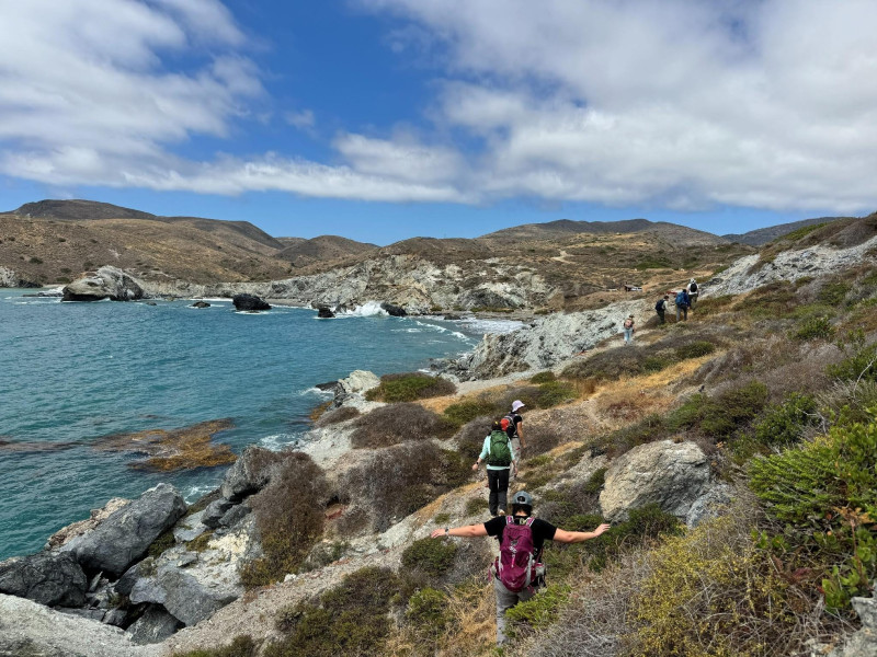 Students enjoying a beautiful sunny hike to rocks along the beach at Little Harbor and Shark Bay.