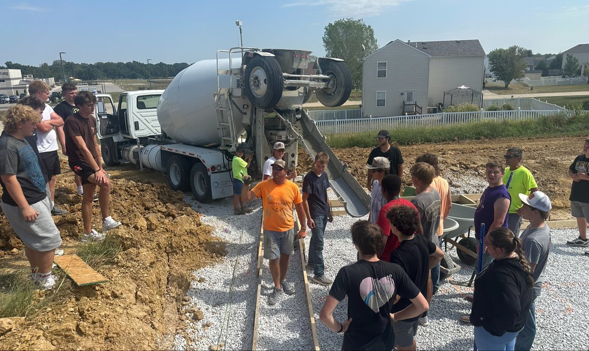 MrMeyersTBHS's tweet photo. @TbhsTech Construction Trades poured concrete today — a porch for the ACES house and footings for the 26/27 Tech House. Teachers and students working side by side. That’s real-world learning done right. Great job today https://t.co/TvV9OcRWsb
