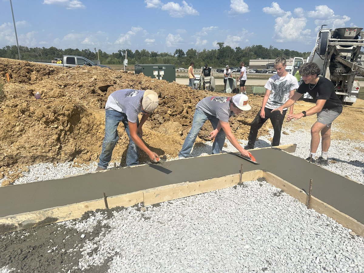 MrMeyersTBHS's tweet photo. @TbhsTech Construction Trades poured concrete today — a porch for the ACES house and footings for the 26/27 Tech House. Teachers and students working side by side. That’s real-world learning done right. Great job today https://t.co/TvV9OcRWsb