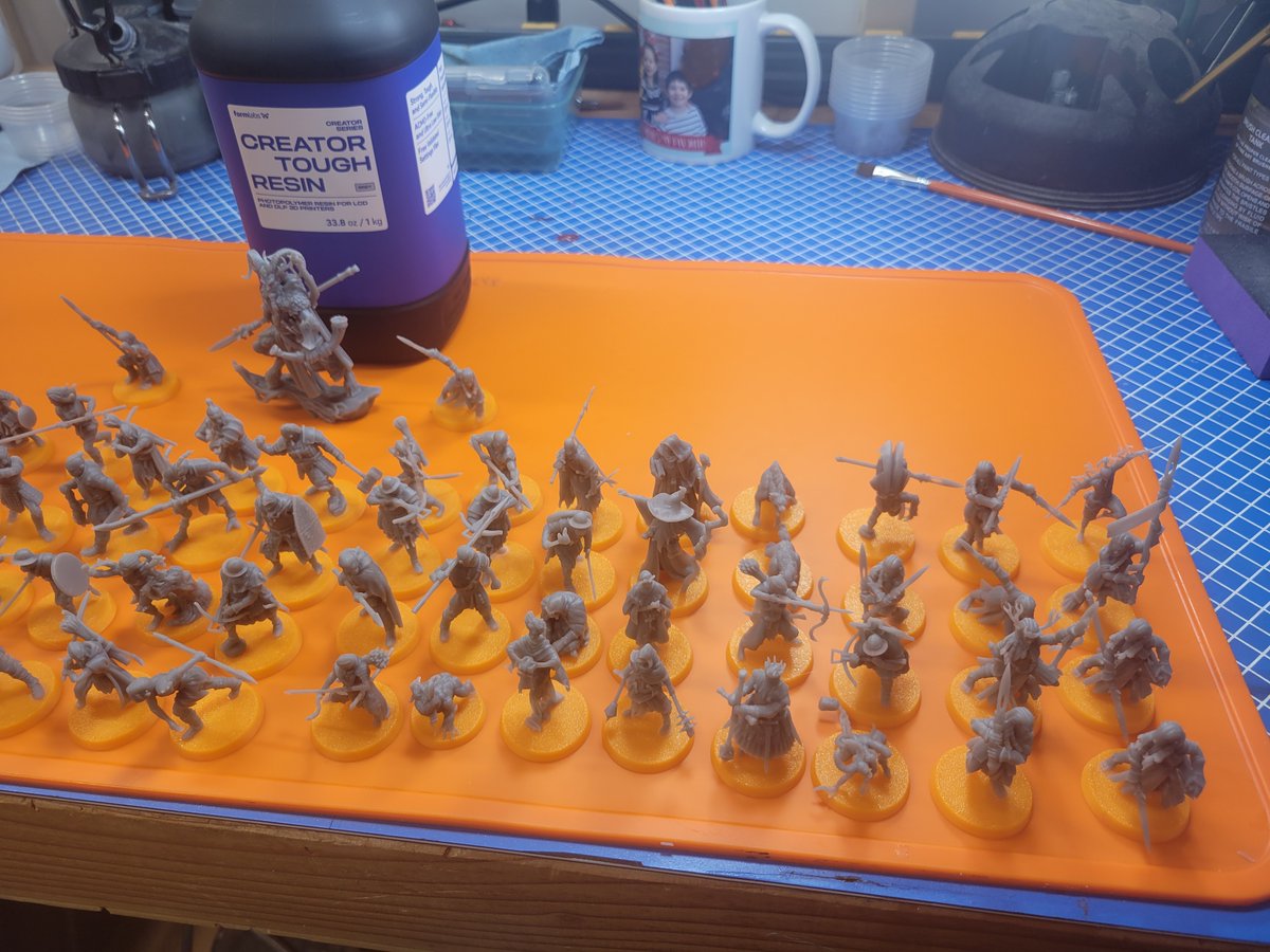 CDuds2024's tweet photo. When I first started 3D printing, I often wondered to myself: How many figures does 1 liter of resin produce?

I'll answer it for anyone curious here, that is 70 infanty/hero sized models and one monstrous creature, plus about 10 failures over that bottle. Everything there came out of the 1L bottle sitting behind them. Five full print plates on an Elegoo Saturn 4.

The failures were not the fault of the printer of STLs, I have resized all of these models to normalize them at 35mm scale, which means I needed to re-support them all as well, and my supports were not always perfect, resulting in 3 or 4 failed models like the one in the last picture where I didn't have sufficient support and something printed incorrectly. There were no complete failures in the whole batch.

The other failures were a result of me removing supports in my usual manner, which is to say like a barbarian tearing a chainmail bikini off.

Now to 6 or 8 hours of priming and applying some basic zenithals... 🤣
