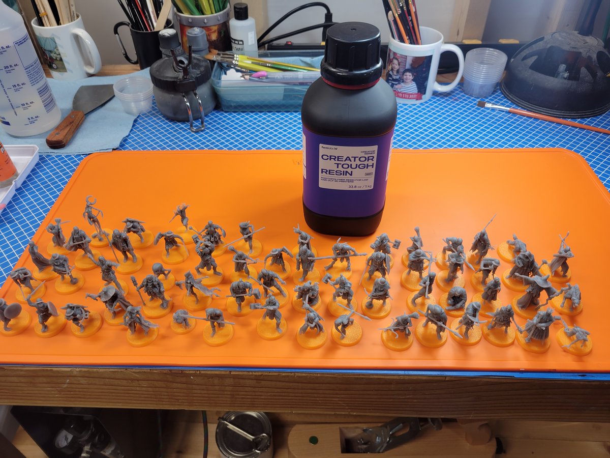 CDuds2024's tweet photo. When I first started 3D printing, I often wondered to myself: How many figures does 1 liter of resin produce?

I'll answer it for anyone curious here, that is 70 infanty/hero sized models and one monstrous creature, plus about 10 failures over that bottle. Everything there came out of the 1L bottle sitting behind them. Five full print plates on an Elegoo Saturn 4.

The failures were not the fault of the printer of STLs, I have resized all of these models to normalize them at 35mm scale, which means I needed to re-support them all as well, and my supports were not always perfect, resulting in 3 or 4 failed models like the one in the last picture where I didn't have sufficient support and something printed incorrectly. There were no complete failures in the whole batch.

The other failures were a result of me removing supports in my usual manner, which is to say like a barbarian tearing a chainmail bikini off.

Now to 6 or 8 hours of priming and applying some basic zenithals... 🤣