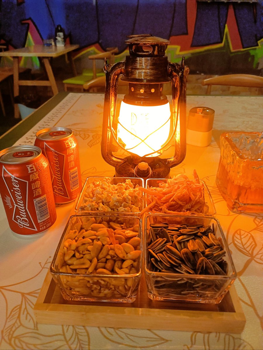 LesliLippgk2's tweet photo. It's 1 a.m., the only warm spot in the quiet lane. My grilled rice ball just hit different here, and the old cat by the booth is judging my last bite. Late-night comfort, just how it should be.， https://t.co/W0KT0e6dRG