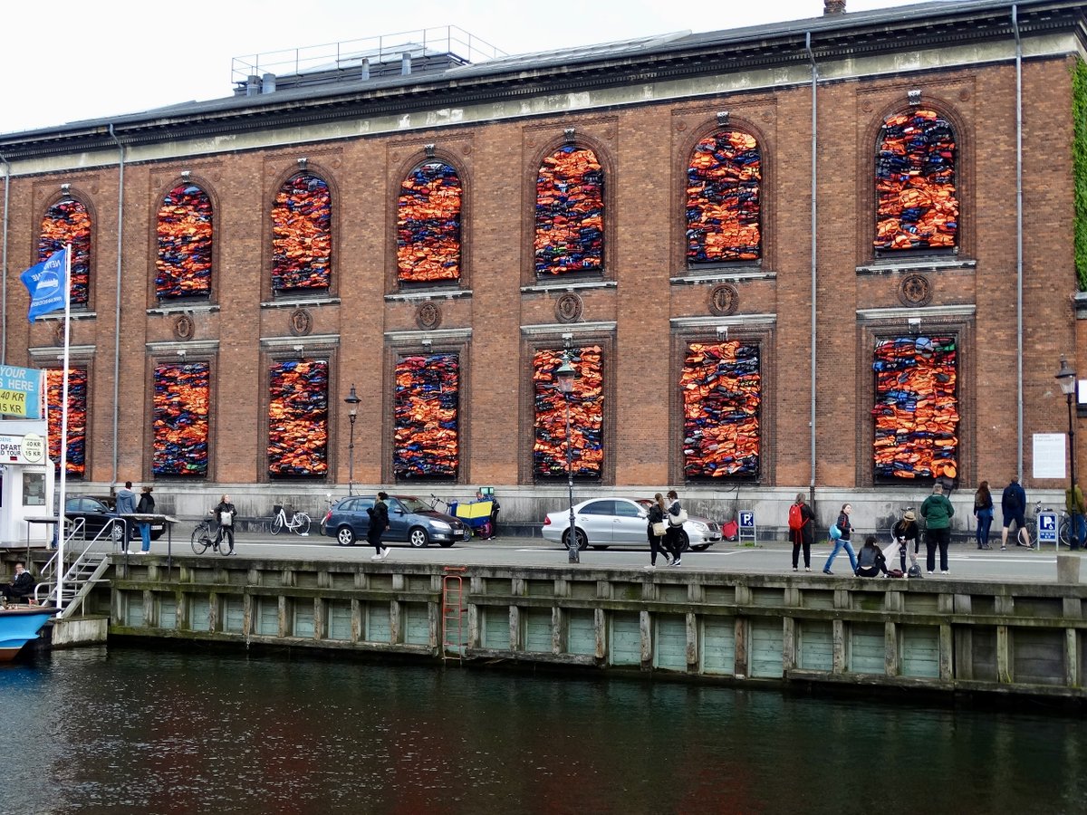 larkinmart's tweet photo. #PMJWeeklyChallenge #Thesamethingmanytimes Life jackets barricade the windows of the Kunsthall Charlottenborg Gallery. This installation by Ai Weiwei used jackets worn by refugees that crossed the Meditterranean between 2015-16 to highlight the unfolding humanitarian crisis https://t.co/1PT5stT7gB