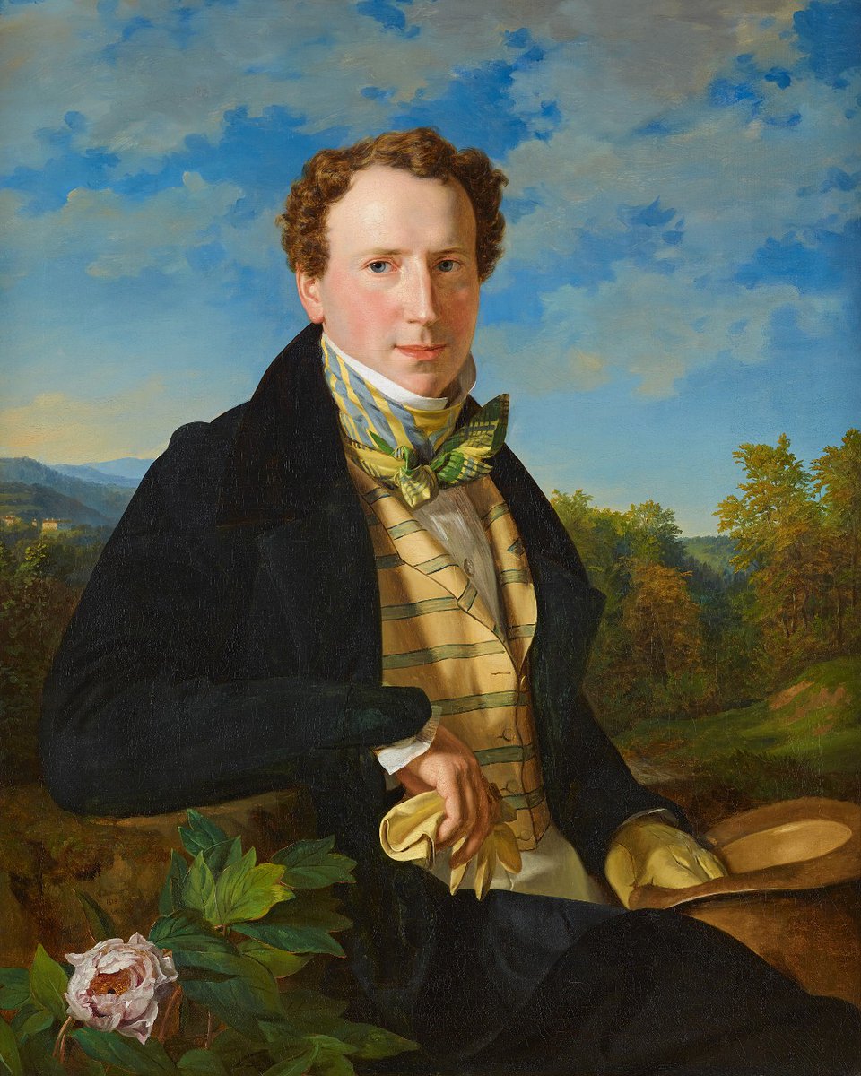 A portrait of a a young man holding a hat, set against a blue sky and distant hills. He wears a formal suit with a patterned waistcoat and a necktie. Ferdinand Georg Waldmüller, 'Self-portrait as a Young Man', 1828 © Belvedere, Vienna.