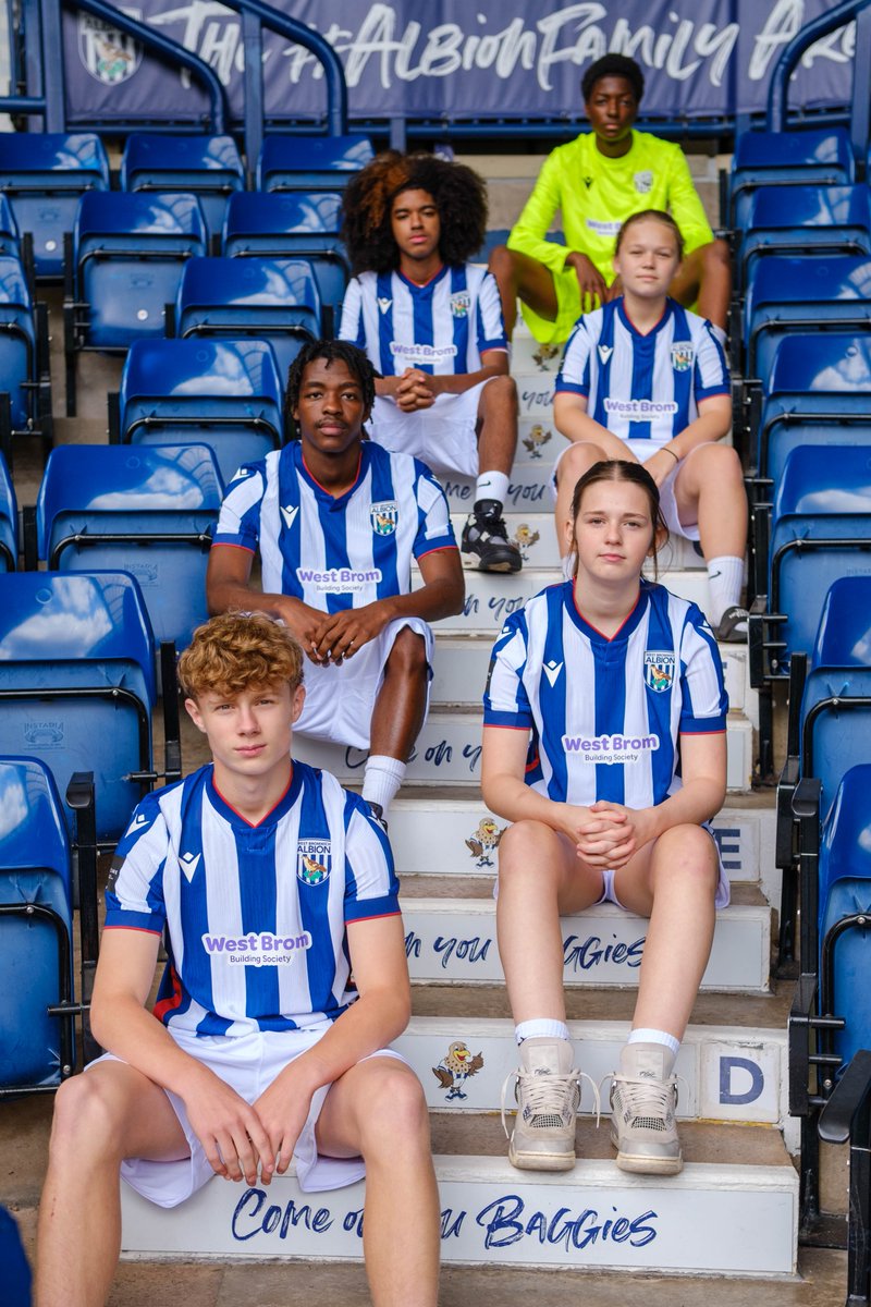 Six Post-16 players sitting on the steps on the East Stand.