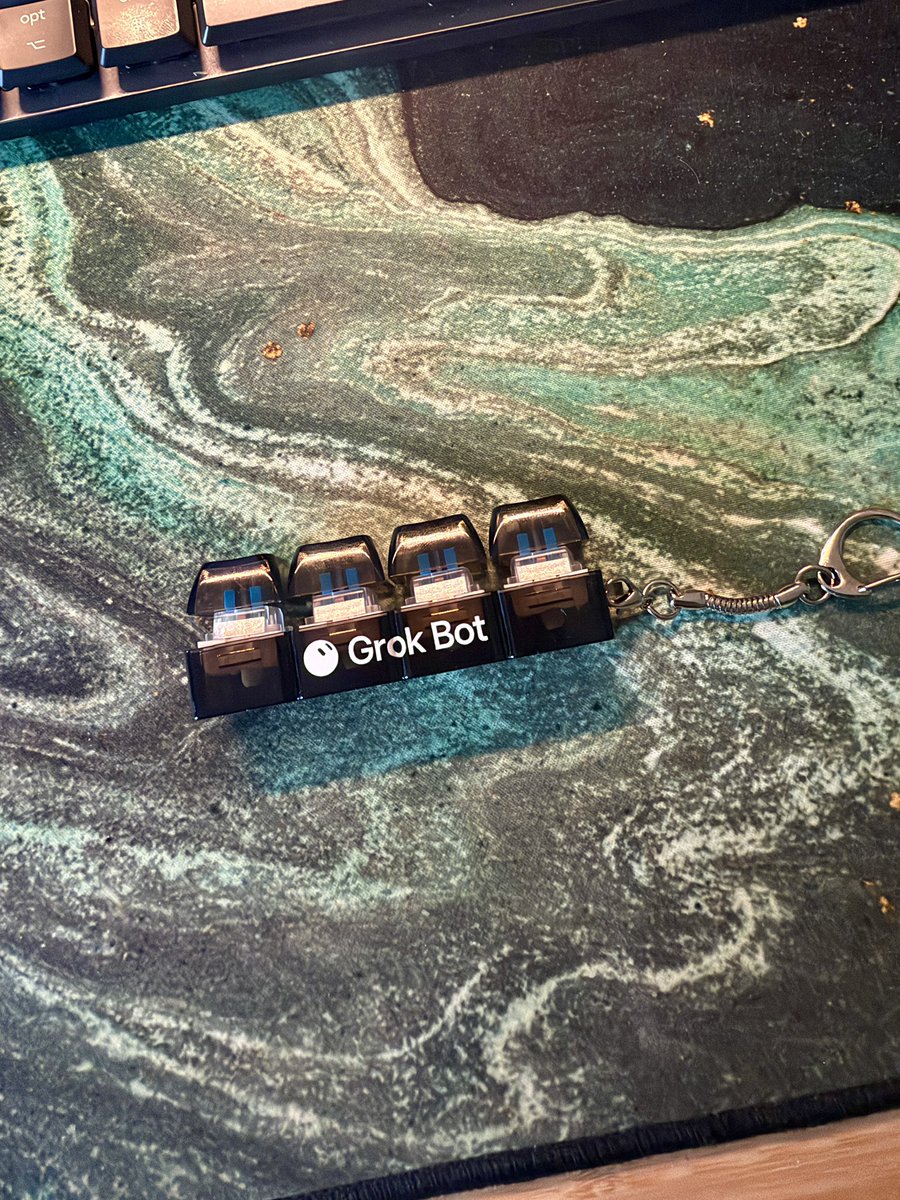 ColmQuish's tweet photo. I have not stopped clicking this @bot keychain doohickey since I got it at Cursor Compile. https://t.co/e1Nh8rLU4O