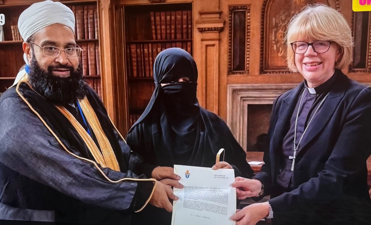 trishaposner's tweet photo. Everyone’s talking about the Church of England 9/11 award photo. But the underlying outrage aside, I can’t stop looking at the woman in the middle, visible only through a slit for her eyes.

In Kabul the morality police enforce that covering. In London we pretend it is freedom. Why aren't human-rights activists who never stop talking about women’s bodies upset about patriarchal control? Is it because  of who practices it?
