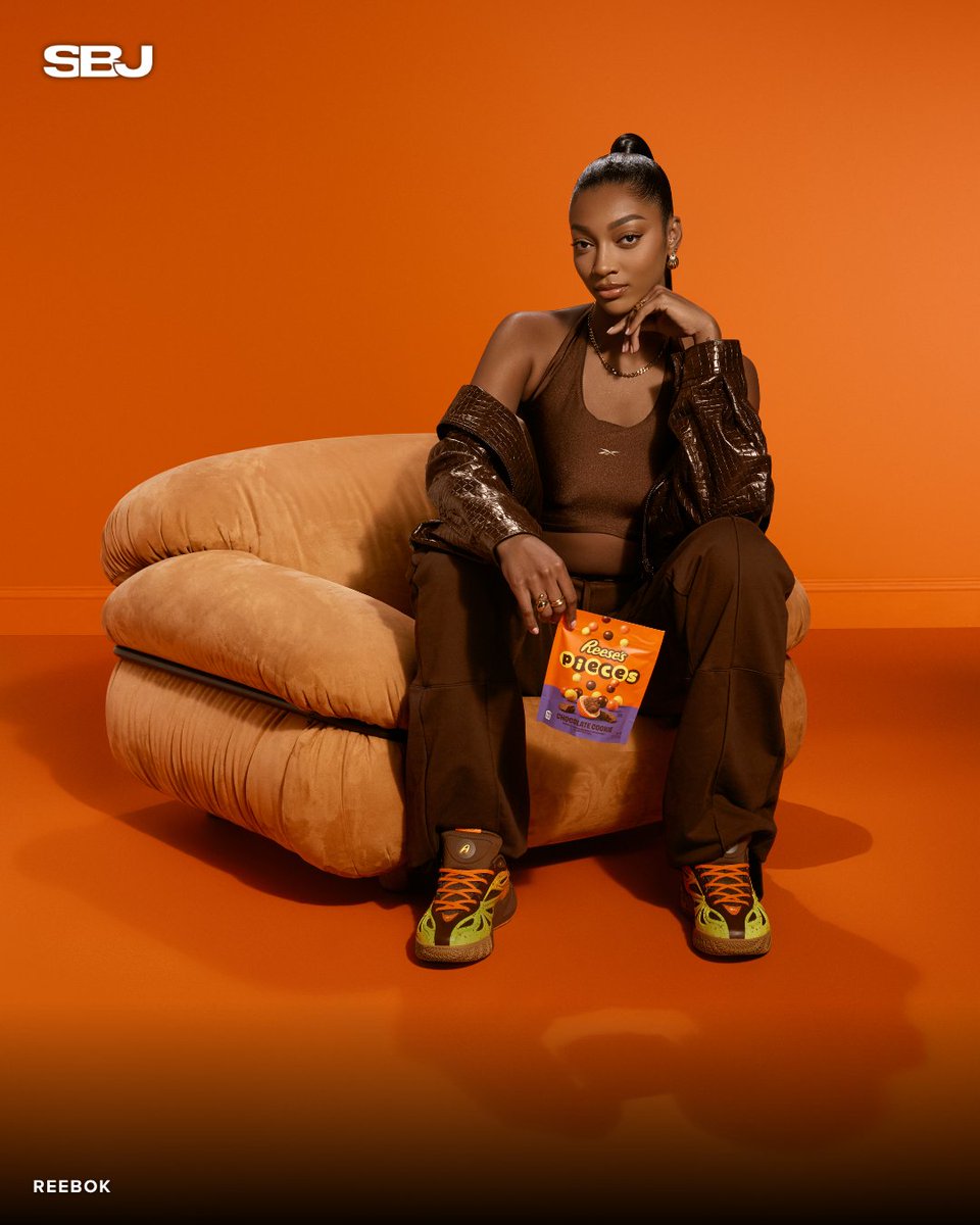 SBJ's tweet photo. The sweetest collab in women's basketball just dropped 🏀 

Angel Reese, Reebok, and REESE'S unveil the Angel Reese 1 'REESE'S' colorway — inspired by the candy's iconic orange, yellow, and brown palette. 

Born from fan demand. Limited-edition orange box included. https://t.co/FA32SrXL6B