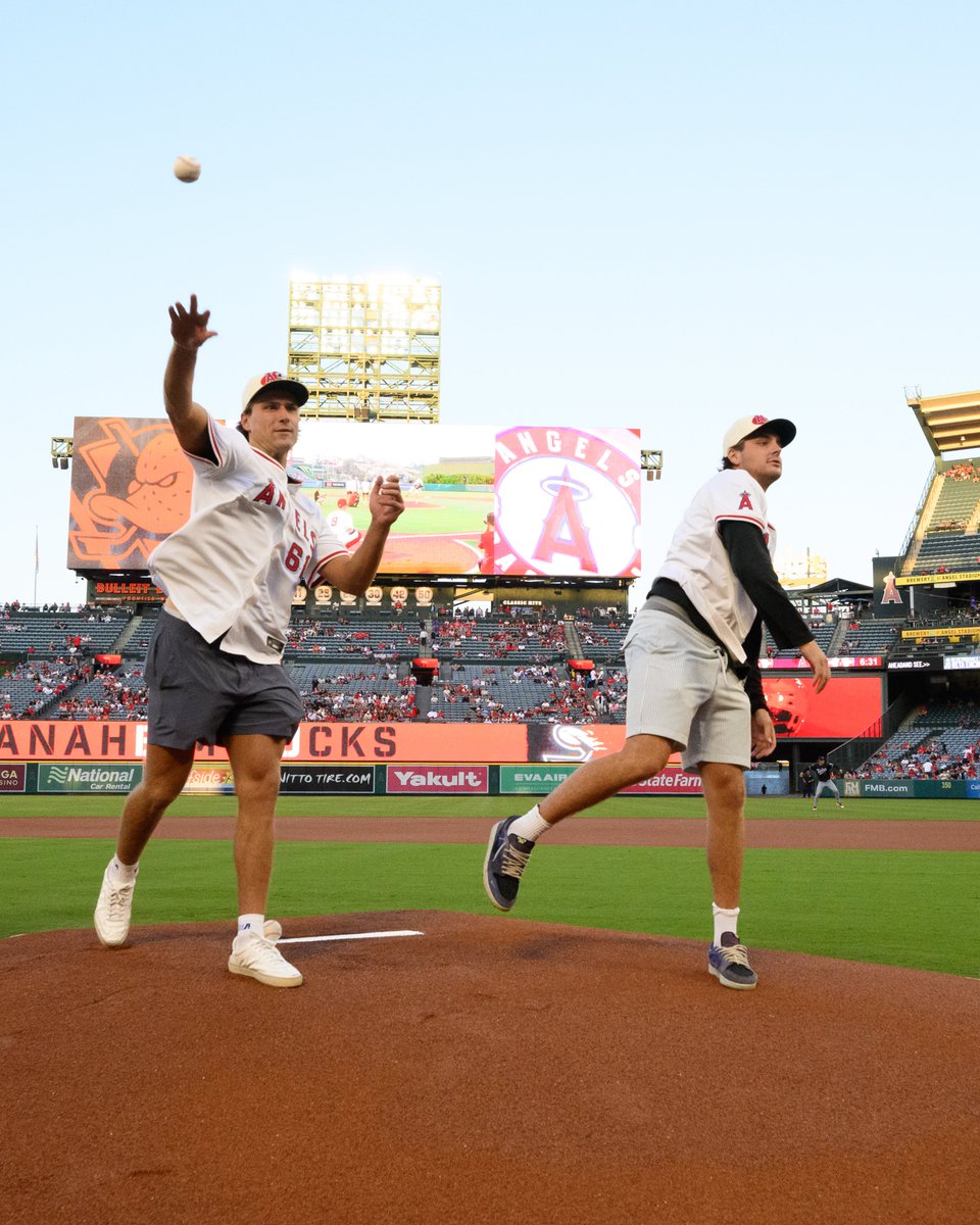 Cutter Gauthier and Leo Carlsson lunge forward as they deliver the ceremonial first pitches.