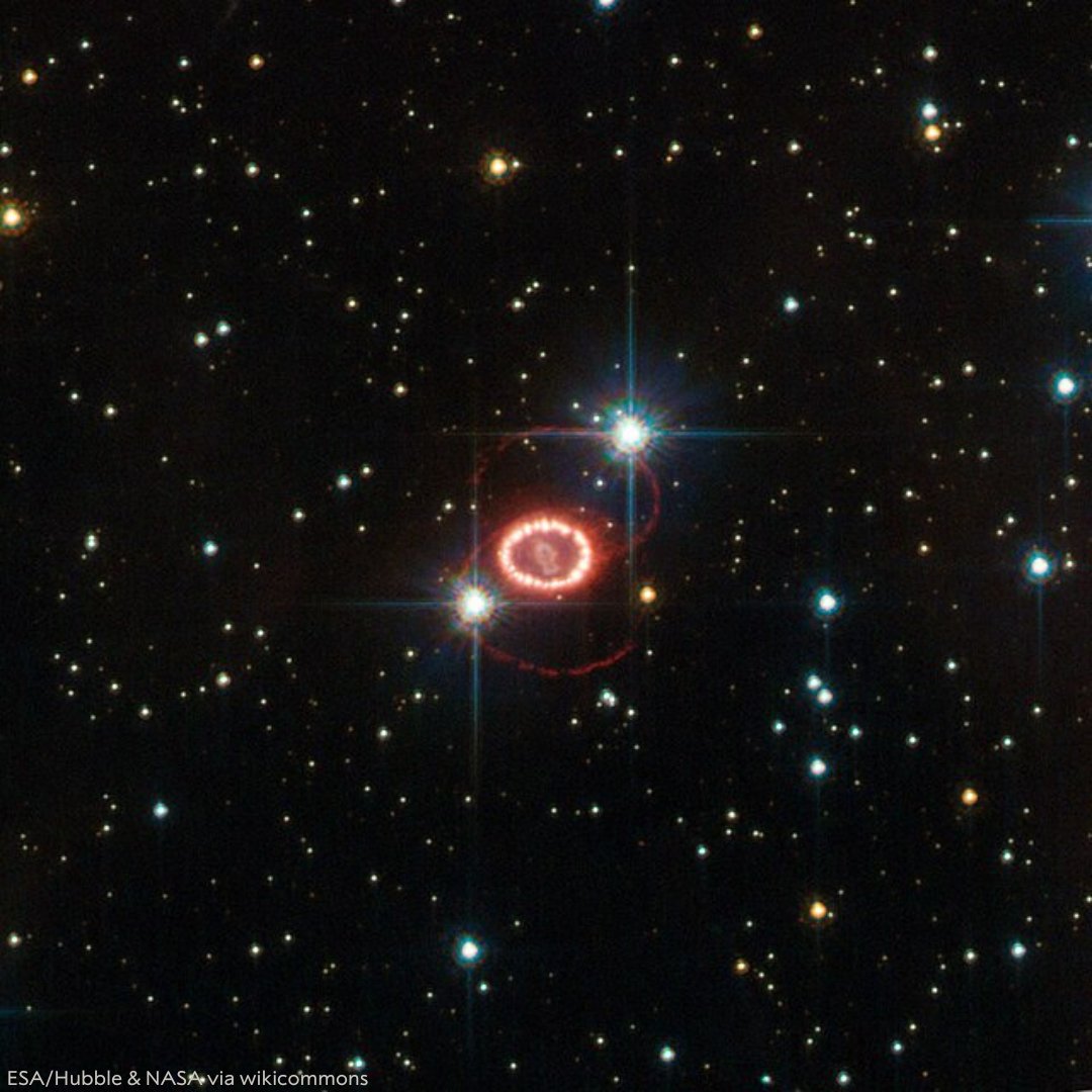 Image of the Red Rectangle Nebula captured by the Hubble Space Telescope, featuring a bright central star surrounded by concentric rings of red and orange dust against a starry background.