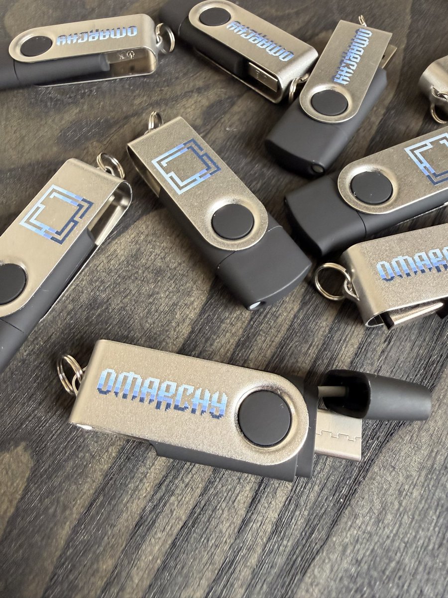 sonderby's tweet photo. So the next batch of OMARCHY merch just landed at my place.. next time you gotta help a coworker install Omarchy, you can look like a pro with this USB key. I’m handing them out at the Copenhagen meetup on 9/28 (100 pcs!)

They’ve got both USB-A and USB-C and they’re 16GB, so you can easily flash the ISO onto them.