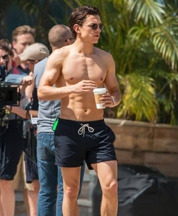 Mossmoviesjo's tweet photo. Tom Holland on an outdoor filming set by the beach. Just another day at work, with a pretty good view... https://t.co/A40ns6uWBV