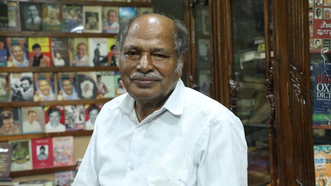 san_x_m's tweet photo. A bus conductor in Karnataka started buying books he could not afford.

He kept doing it for 50 years.

He sold his house to keep doing it.

He now owns 2 million books, and he lets anyone read them for free.

His name is Anke Gowda.

He is 79. He was born into a farming family in Chinakurli, in Mandya district. Books in that house were a luxury nobody could justify.

He worked as a bus conductor. Later he was a timekeeper at a sugar factory, which is the man who records when each shift starts and ends.

Neither job pays enough to build a library.

So most of what he earned went into books, decade after decade. When that was not enough, he sold property. His family lived with the consequences of that choice for 50 years.

The collection is now housed in a purpose built building of about 1,500 square metres in Pandavapura, funded by a businessman named Hari Khoday after the books outgrew everything else.

It is called Pustaka Mane. The House of Books.

What is inside it is difficult to take in.

More than 2 million volumes. Books in over 20 Indian and foreign languages. Rare editions going back to 1832, which is nearly 200 years of publishing history. Around 5,000 dictionaries. Science, technology, philosophy, mythology, religious texts, rare editions of the Bible.

He knows where things are. Not a catalogue. Him.

There is no membership fee. There is no membership. Schoolchildren walk in. So do researchers, teachers, farmers and students preparing for the civil services examination.

Anke Gowda, his wife Vijayalakshmi and their son Sagar live inside the library.

Not next to it. In a corner of it.

In January 2026 the government of India gave him the Padma Shri, in the Unsung Heroes category.

He was a conductor on a Karnataka state bus who noticed that most of the people getting on and off had no access to a book in their life.

So he spent the next 50 years fixing that for them, one purchase at a time, out of a salary that was never meant to stretch that far.