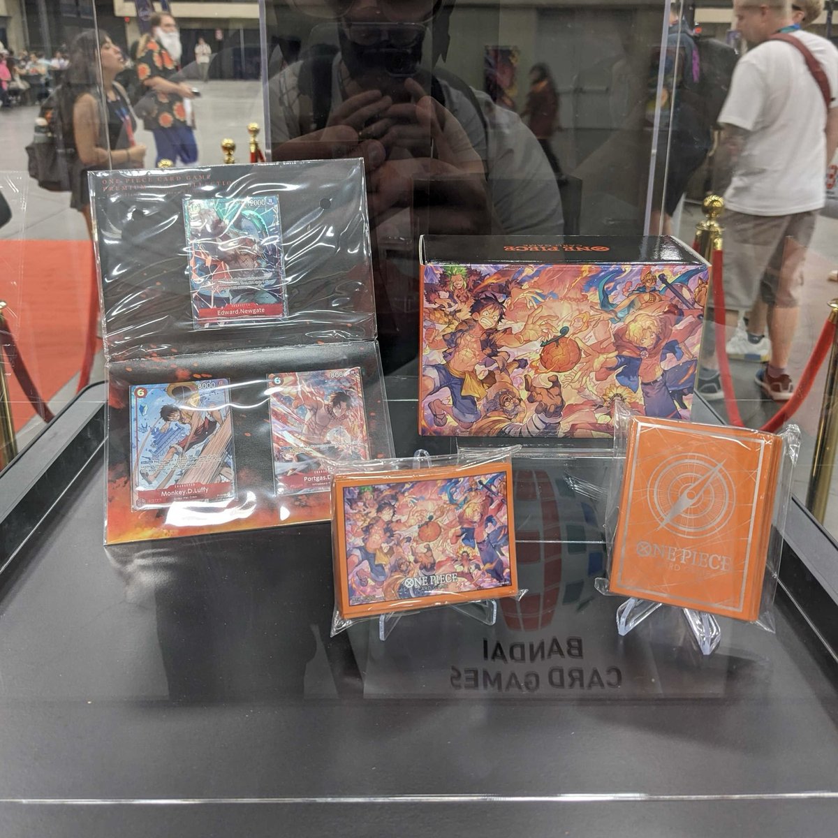 AndyCollectz's tweet photo. In-person shots of some of the OPTCG Flame Flame Fruit Exclusive Products!

-Premium Card Collection Flame-Flame Fruit Coliseum Edition
-Official Storage Box Flame-Flame Fruit Coliseum Edition
-Limited Card Sleeve Flame-Flame Fruit Coliseum Edition
-Limited Card Sleeve Standard Orange Silver