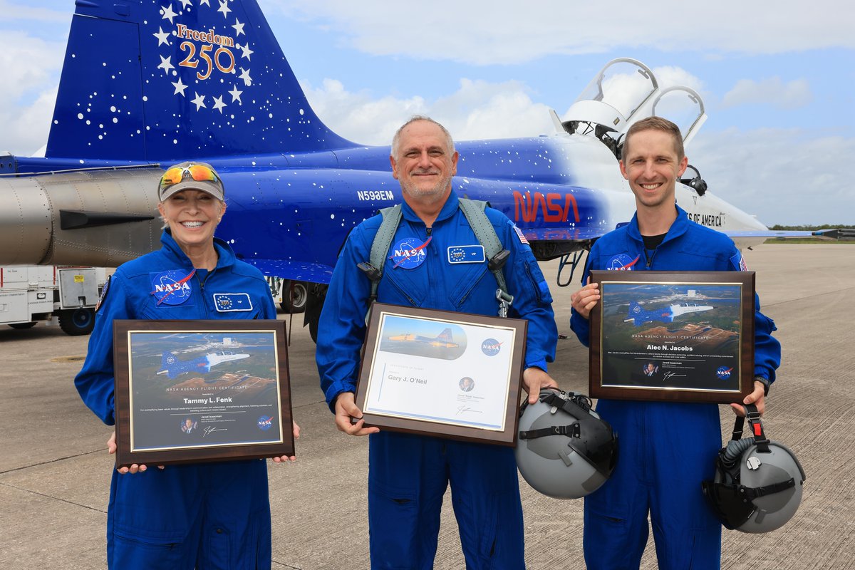 From left, NASA employees Tammy Fenk, Gary O’Neil, and Alec Jacobs pose for a photograph after participating in an employee incentive flying event using NASA Administrator Jared Isaacman's personal F-5 aircraft, Thursday, Sept. 17, 2026, at NASA’s Kennedy Space Center in Florida.