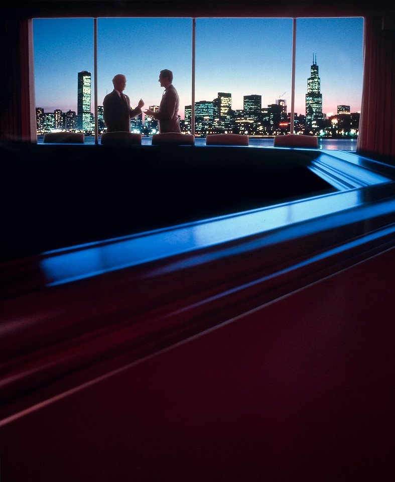 Ortgeist's tweet photo. I enjoy this period of corporate romanticism during the 1980s and 90s where ambition, possibility, distance and hierarchy were on full display.

Contemporary corporate imagery prefers the language of openness and accessibility, along with an artificial assurance that you're already there.

Image by Kent Hanson, 1990