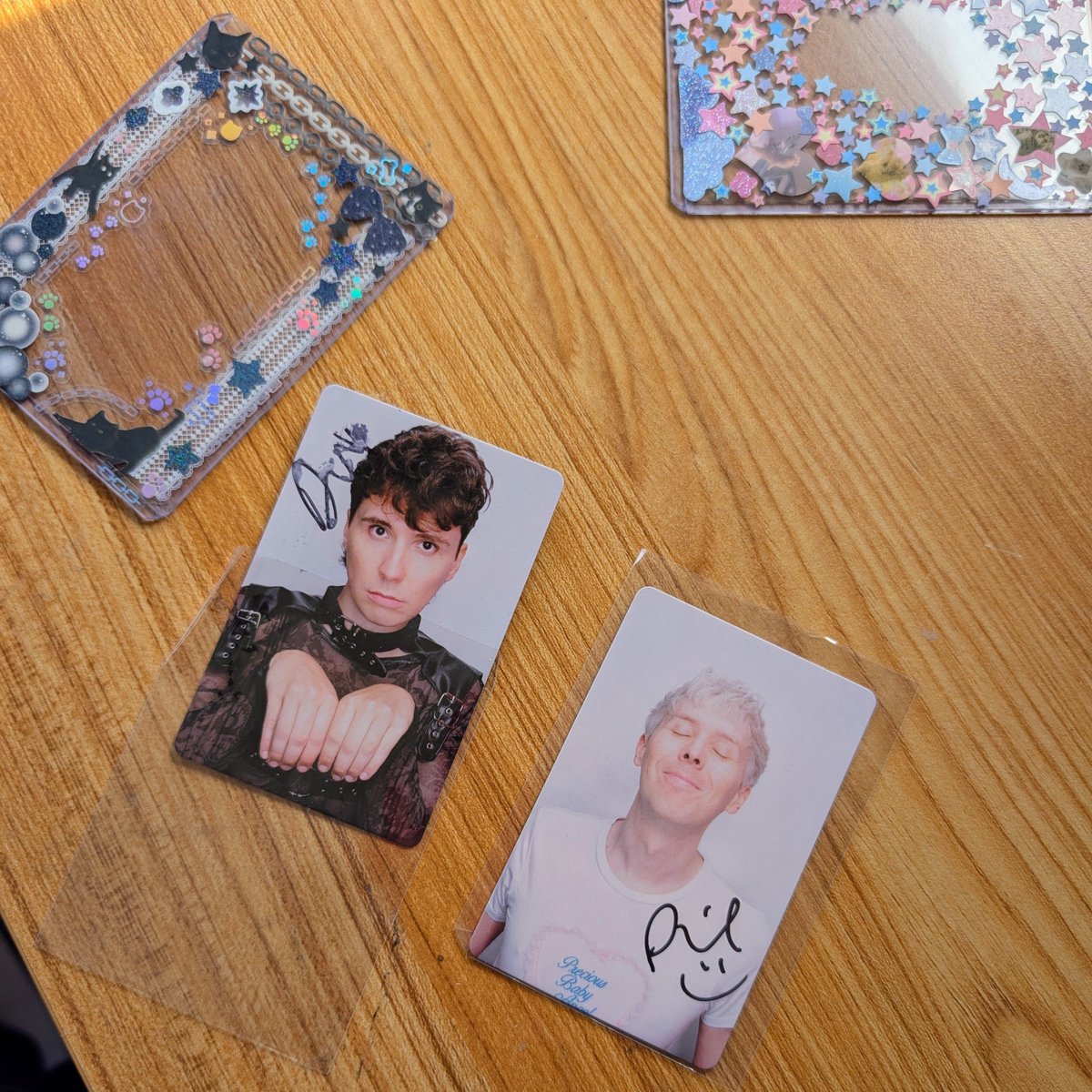 fourtysteps's tweet photo. dan and phil each signed a photocard for me and phil nicely took his out of the toploader and handed it back to me out of the case so the sharpie could dry first but dan just shoved his back into the holder right away and smudged the shit out of it. it's authentic and I love it https://t.co/WNYeN3gEdy