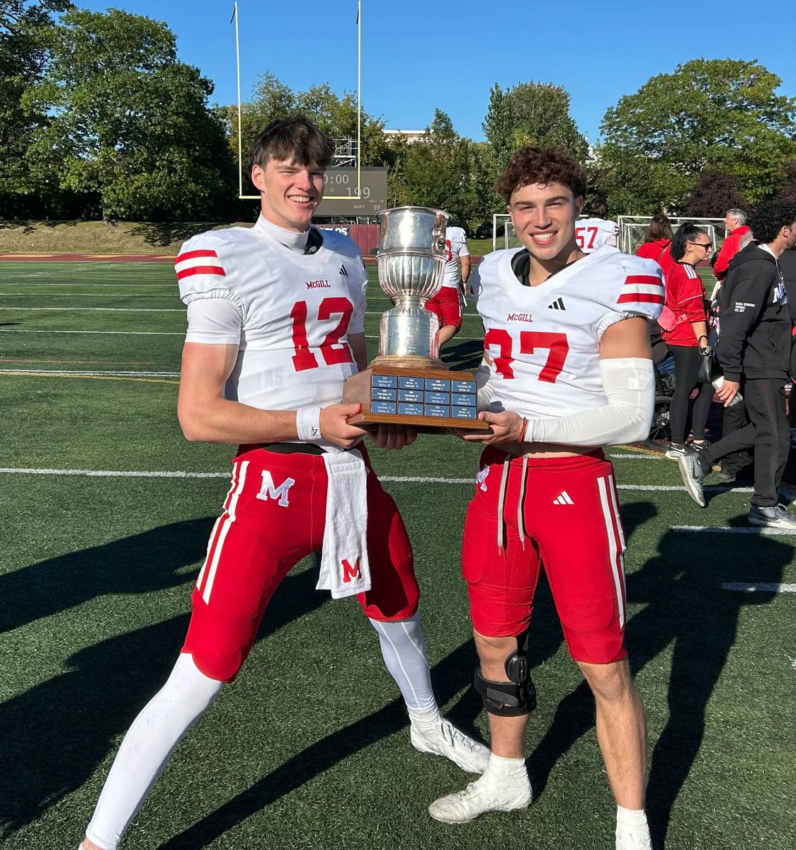 McGillAthletics's tweet photo. Two freshmen admiring the lore of a satisfying Shaughnessy Cup victory over Concordia, quarterback Elliott Drapeau (12) of Quebec City and defensive back Joseph Korenblit (37), a native of Paris, France. https://t.co/mysV1ZDvcG