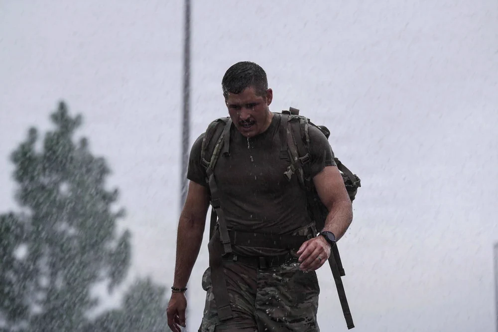 Soldiers run in the rain