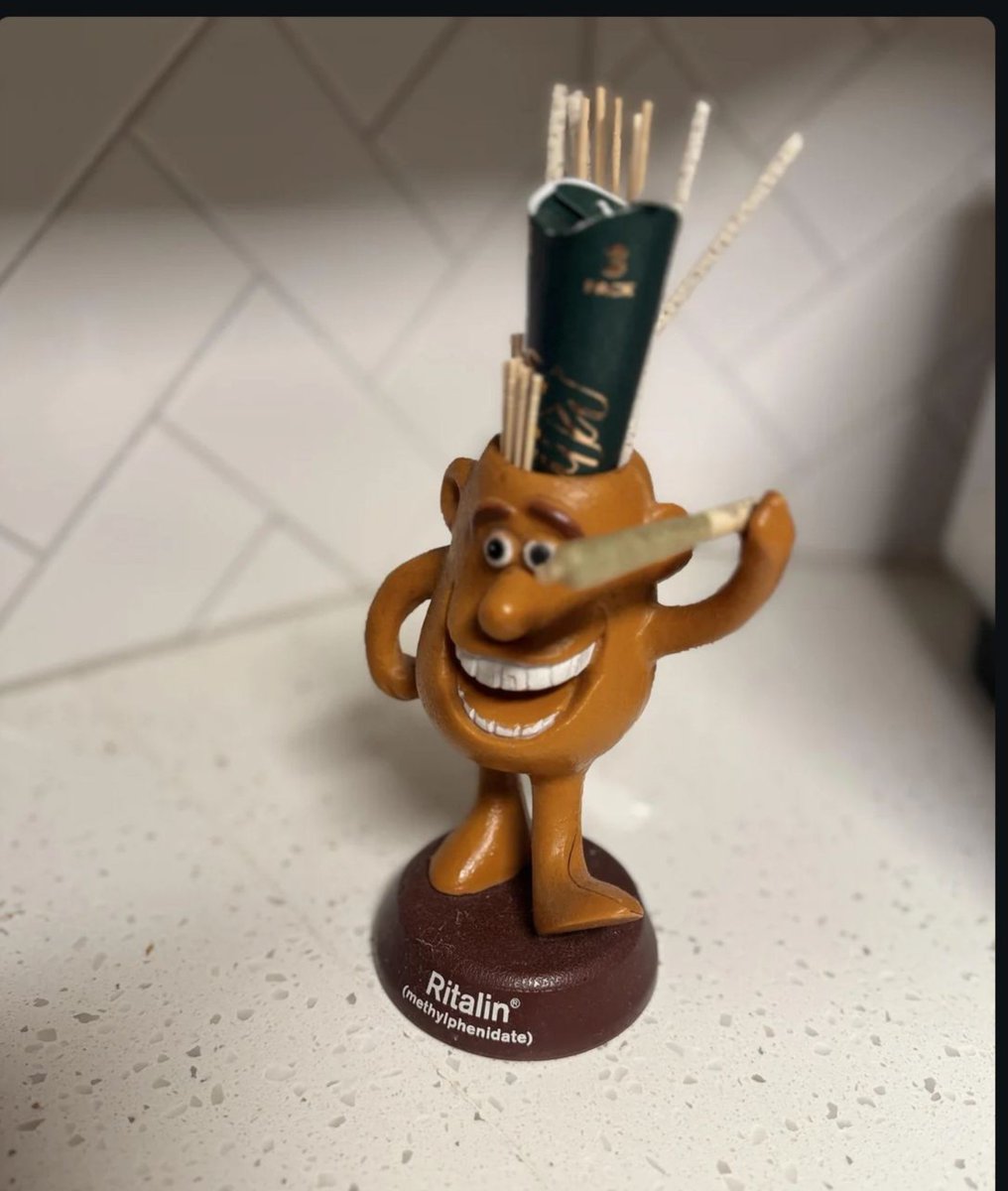 negscottt's tweet photo. pre-CSA ritalin homonculus

my grandfather was a government sales rep for ciba-geigy in the 60s and 70s after he left the USN submarine service. he had a fondness for ritalin, even had a 20’ ski boat named “miss ritalin” and always kept a stash in his safe with his pistol and poker money. SWORE by the stuff. i can confirm: genuine ciba brand ritalin is flat out amazing 😂

this little fella used to have a little straw boater hat in the raised hand. alas, its long missing so i substituted a freshly rolled chop, nowadays i keep weed accoutrements in the pen reservoir. the lack of “CII” tells me this weirdo was manufactured sometime before the Comtrolled Substances Act of 1970 made such labels mandatory. way back when the DEA was just a glimmer in a bureaucrat’s eye they even gave the reps SAMPLES. boy howdy what an age.