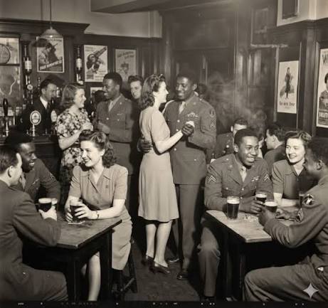 blackJournals01's tweet photo. American military police tried to impose a colour bar on an English village in 1943.

The village's three pubs responded by putting up signs reading: BLACK TROOPS ONLY. Bamber Bridge, Lancashire.

Black American soldiers were stationed there and the locals liked them. When the US Army asked the village to segregate its pubs, the publicans complied in the most English way available — by barring the white Americans instead.

On the night of 24 June 1943, white American MPs came to arrest a Black soldier at Ye Olde Hob Inn for a uniform infraction. British civilians and British soldiers in the pub intervened and told them to leave him alone.

It escalated into a night of shooting between Black GIs and American MPs. One Black soldier, William Crossland, was killed.

Dozens were court-martialed. British witnesses testified about the MPs' conduct, and sentences were reduced. The US Army quietly reorganised how MPs were deployed in the area.

An English village looked at American segregation, understood it immediately, and refused to host it.
The pub is still there. The sign is part of local legend.