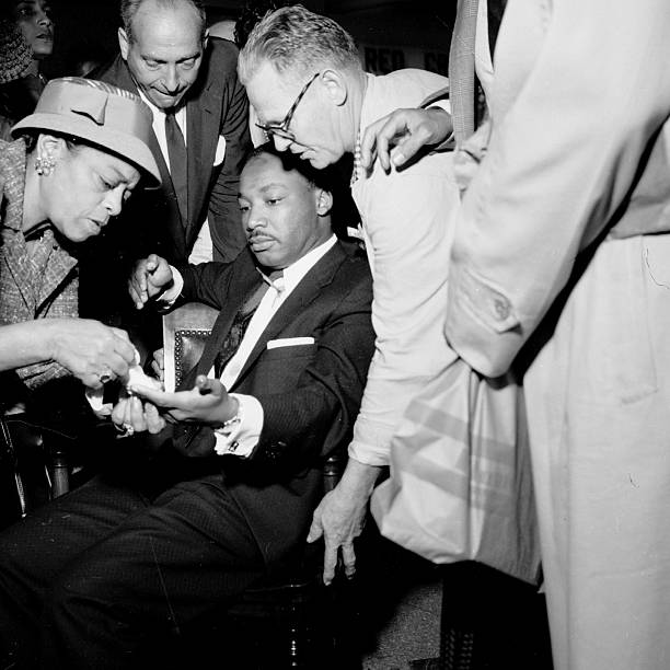 TheKingCenter's tweet photo. On this day in 1958, Dr. Martin Luther King, Jr. was stabbed in the chest by Izola Curry while signing copies of “Stride Toward Freedom” at a department store in Harlem.

The seven-inch blade came dangerously close to his aorta. Doctors later said that a sneeze or cough could have proved fatal.

Dr. King survived. But what followed became an enduring testament to the power of nonviolence.

From his hospital room, Dr. King expressed no hatred toward Curry. Instead, he spoke of her humanity and expressed hope that she would receive the help she needed. His response is a reminder that nonviolence is not weakness. It is the courageous decision to reject hatred, even when hatred has been directed at you.

Today, we remember Dr. King’s survival—and recommit ourselves to the work he yielded his life to advance:

HEAL HUMANITY.
HONOR TRUTH.
PRIORITIZE JUSTICE.
PRACTICE NONVIOLENCE.

The work continues. The Beloved Community is still possible—and it requires all of us.

#TheKingCenter #MartinLutherKingJr #MLK #Nonviolence #BelovedCommunity #CorettaScottKing

2nd photo: A letter opener protruding from his chest, Dr. King was treated at W. 123rd St. police station. (Photo by Vernoll Coleman/NY Daily News Archive via Getty Images)

3rd photo: Martin Luther King Jr. recovers from surgery in bed at Harlem Hospital in New York City on September 21, 1958, following an operation to remove a letter opener from his chest. (John Lent / AP)

4th photo: New York Governor Averell Harriman, left, talks with the Rev. Martin Luther King and his wife Coretta Scott King in Harlem Hospital, New York, Sept. 22, 1958. (AP Photo/Ray Howard)