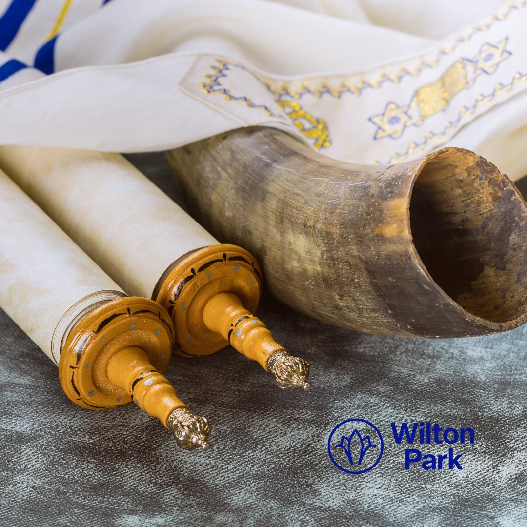 Symbols of Yom Kippur on display, including scrolls and a shofar