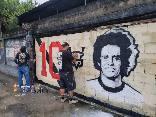 tawannabrito's tweet photo. Desde o falecimento do Dinamite, em janeiro de 2023, havia um grafite em homenagem ao Maior de Todos, na Av. Roberto Dinamite. Na noite de sexta-feira (18), para a surpresa de todos, descobrimos que o muro foi apagado e substituído sem o consentimento dos artistas. https://t.co/9bC8NWXrxq