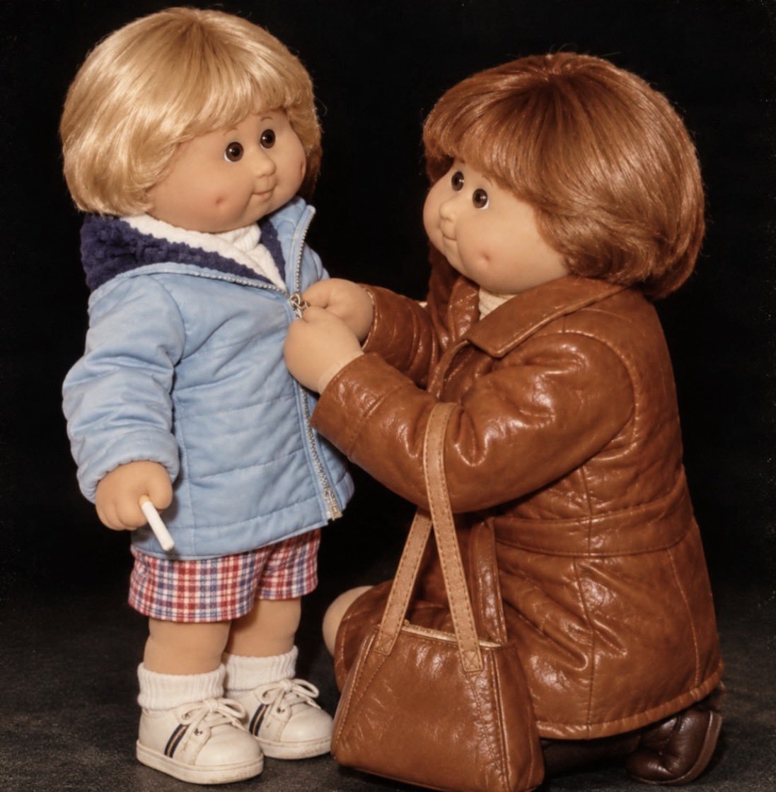 TwoLostSouls14's tweet photo. Me in 80s holding my mum's cig while she zipped my jacket up. https://t.co/dQhLjOwU6E