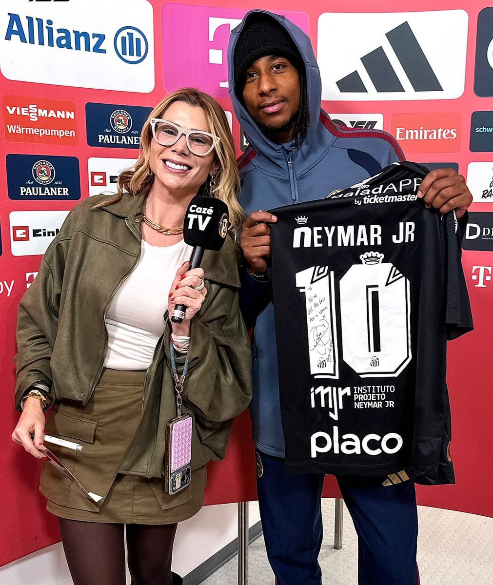 iMiaSanMia's tweet photo. Brazilian journalist Isabela Pagliari, who brought Neymar's jersey to Michael Olise after the Union Berlin game, explains to @BILD how the meeting came about and how she managed to make the Frenchman, who usually doesn't like interviews, 'open up':

"I wouldn’t say that I got him to open up. Only Michael can explain why he felt comfortable talking to me at that particular moment. I can only describe how I approached him. I had been told beforehand that he would probably just accept Neymar’s shirt that I had brought for him, say thank you and walk away.

A week before I left for Germany, I was at the gym scrolling through Instagram. I saw that Olise had answered a question about his GOAT with ‘Neymar’. I immediately messaged Neymar and told him about it. We know each other well from his time in Paris. Within three days, a new shirt, specially signed for Michael, arrived at my place. Neymar then asked me for something in return: one of Michael’s shirts.

When Michael arrived, the camera was already rolling. The first thing I asked was, ‘Can I give you a hug?’ He said yes, so I hugged him and then handed him Neymar’s shirt. I think the fact that we had met before helped make the interaction feel more natural. But the gesture was genuine. I wanted to give him something meaningful, and I didn’t want to use the shirt as a means of getting an interview.

After the game, I interviewed Kane and Saibari, but Michael still hadn’t shown up. I told Saibari that I wanted to give Michael a shirt signed by Neymar, and I asked him if he could let Michael know. He immediately said, ‘I’ll go and tell him.’ And he went back inside.

I was told that he doesn’t do that to create a certain image for himself. Rather, he is naturally a quiet, reserved and shy person. When he is surrounded by people he knows, he can naturally show more of himself.

It was a very brief interaction. What I remember most is the moment itself. Michael seemed genuinely happy when he received the shirt. He smiled, appeared relaxed, and immediately went to get one of his own shirts and signed it for Neymar."