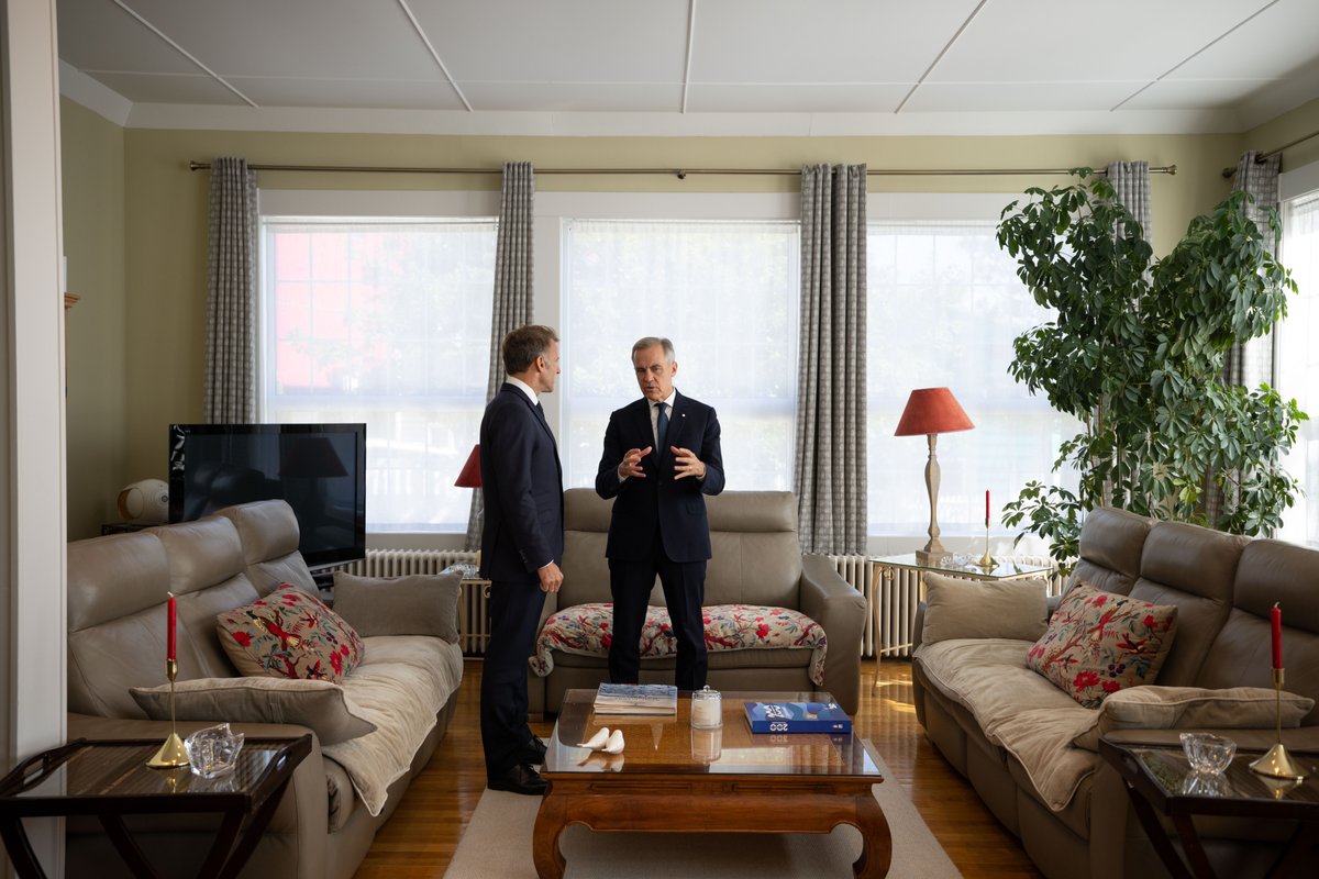 Prime Minister Mark Carney speaks with the President of France, Emmanuel Macron, during a meeting in Saint-Pierre-et-Miquelon, France.