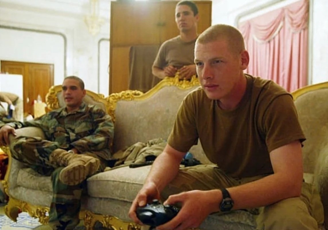 specialopsmag's tweet photo. US soldiers relaxing and playing Xbox on an ornate, gold-trimmed couch inside one of Saddam Hussein’s former palaces in Iraq, shortly after the invasion in 2003. https://t.co/pdhyk72nMB